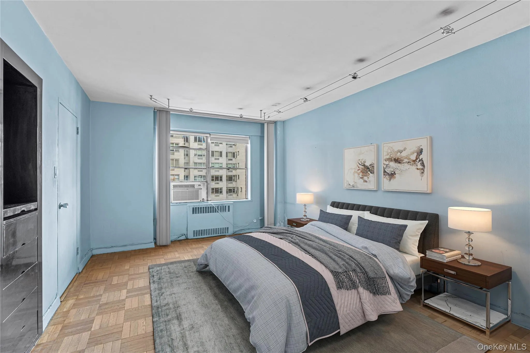 Bedroom with track lighting, cooling unit, and radiator Bedroom with track lighting, cooling unit, and radiator