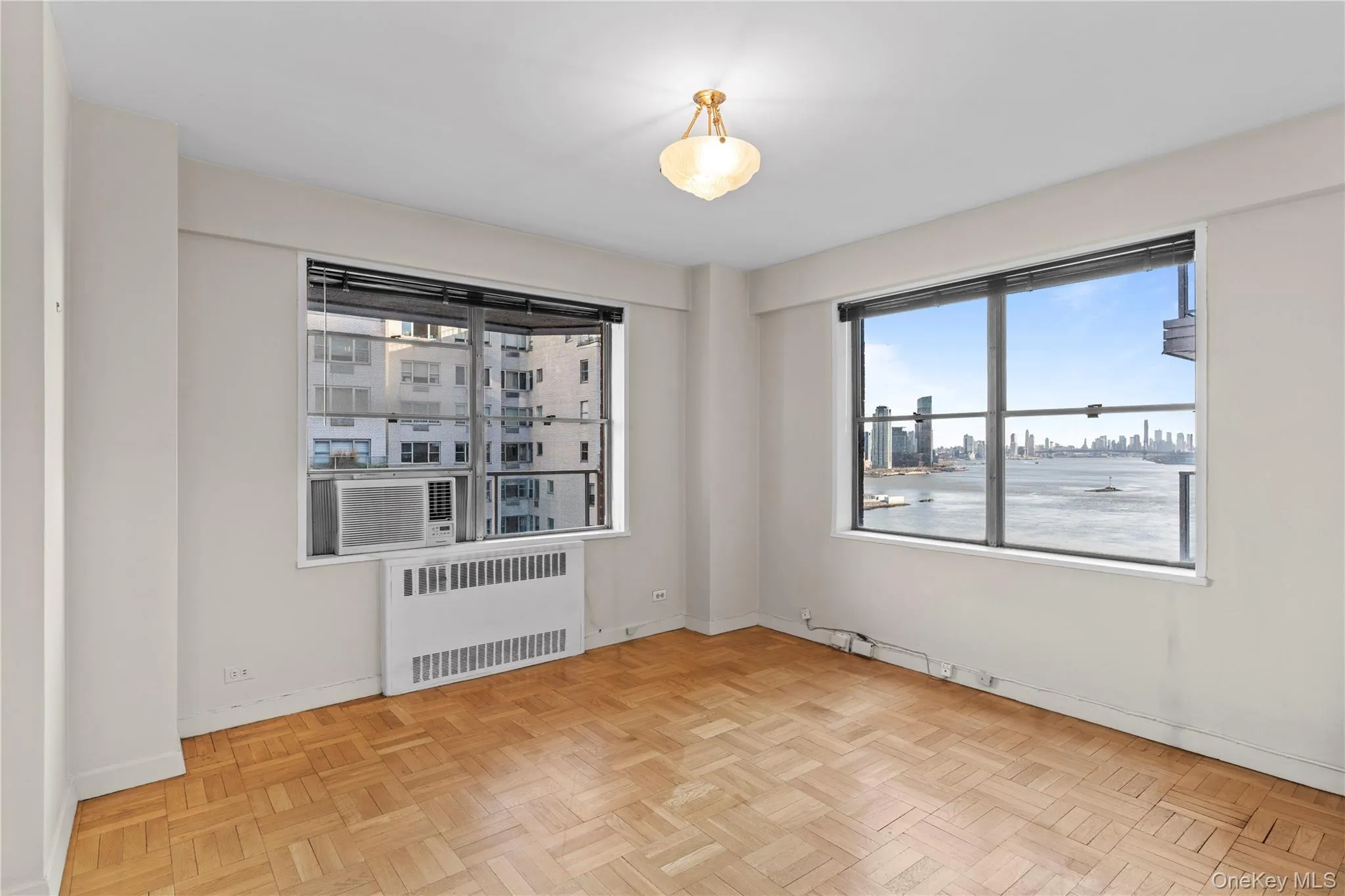 Unfurnished room with radiator and baseboards Unfurnished room with radiator and baseboards