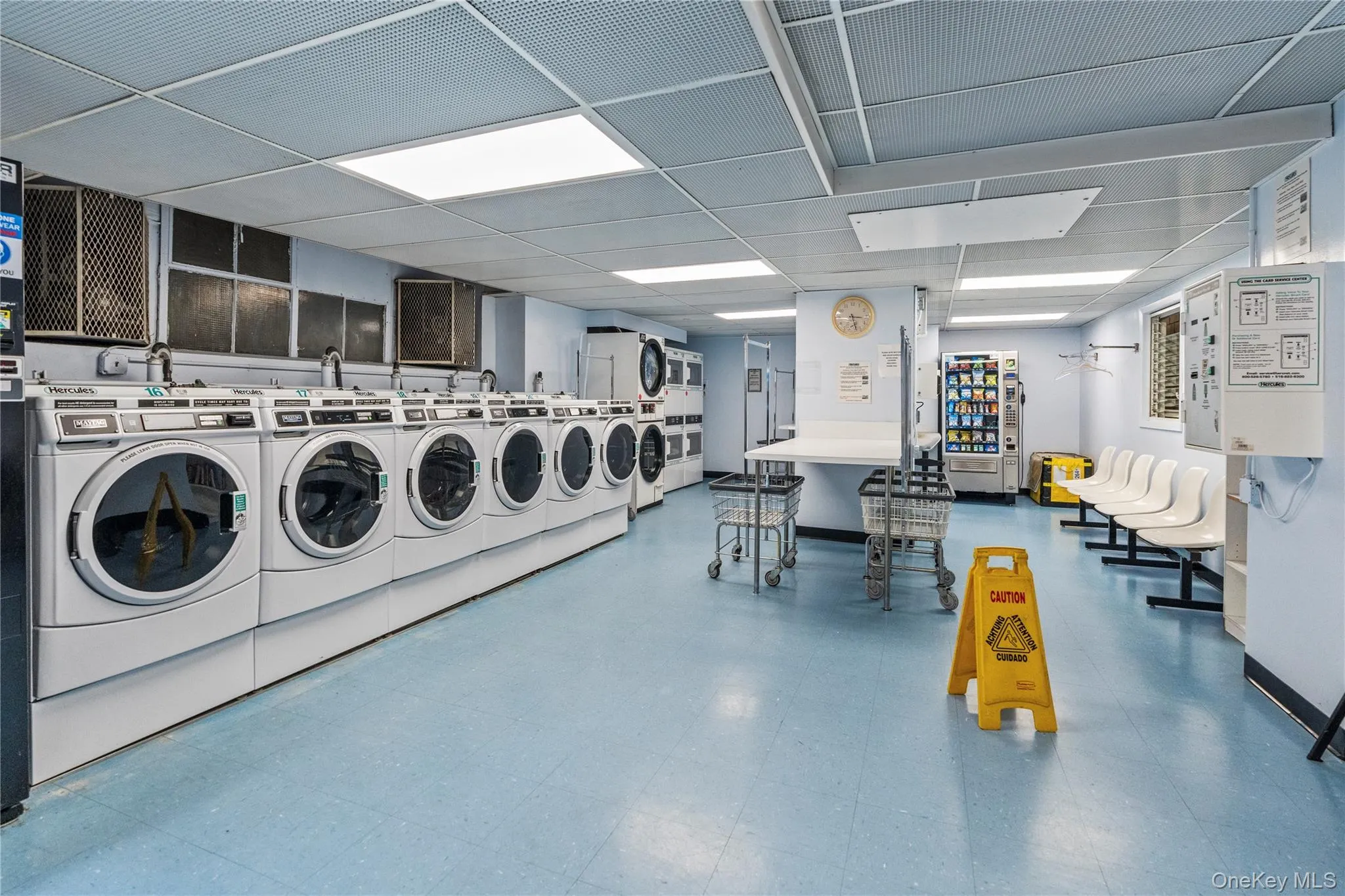 Shared laundry area with washer and clothes dryer and tile patterned floors Shared laundry area with washer and clothes dryer and tile patterned floors