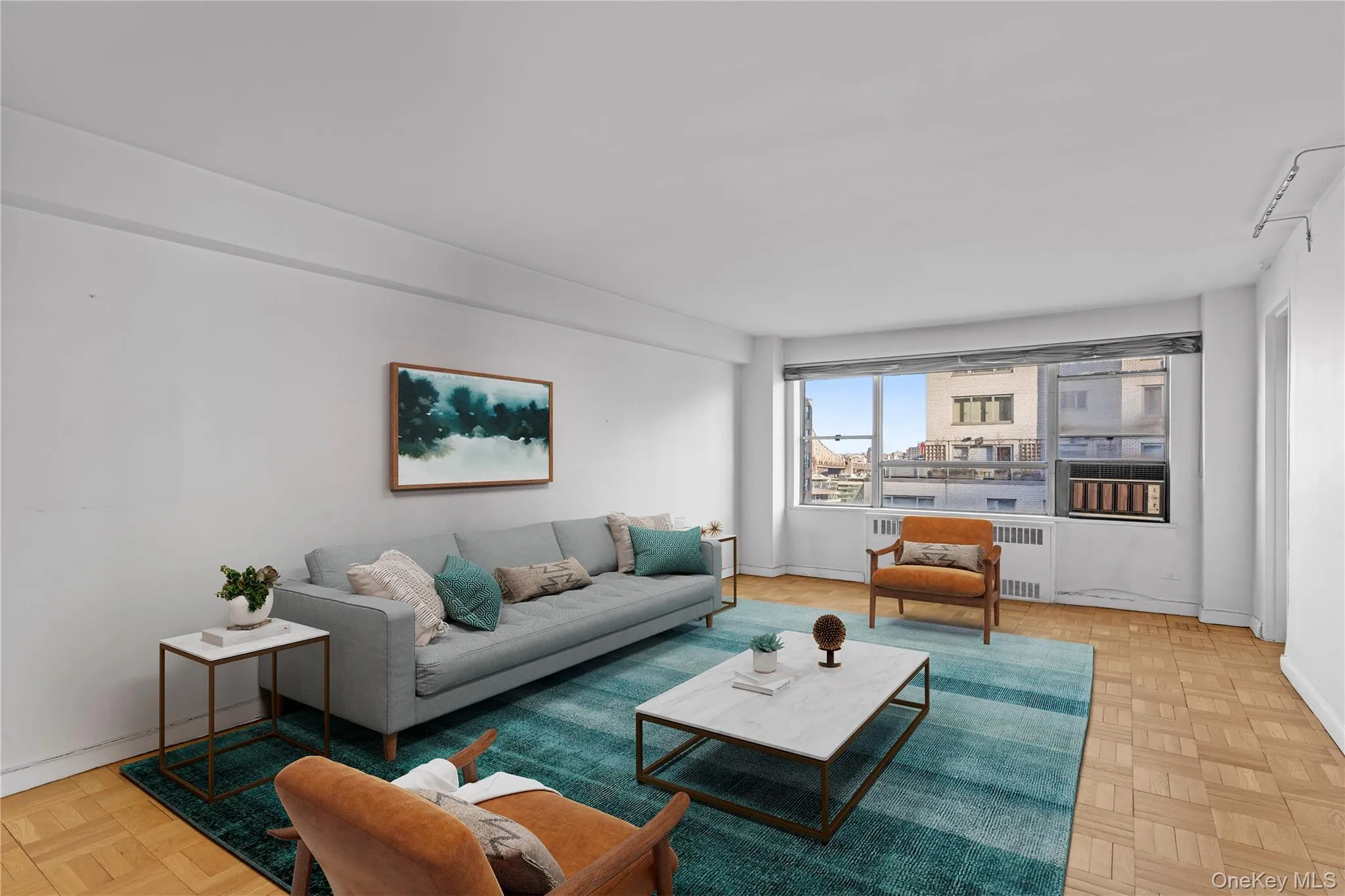 Living area featuring radiator and baseboards Living area featuring radiator and baseboards