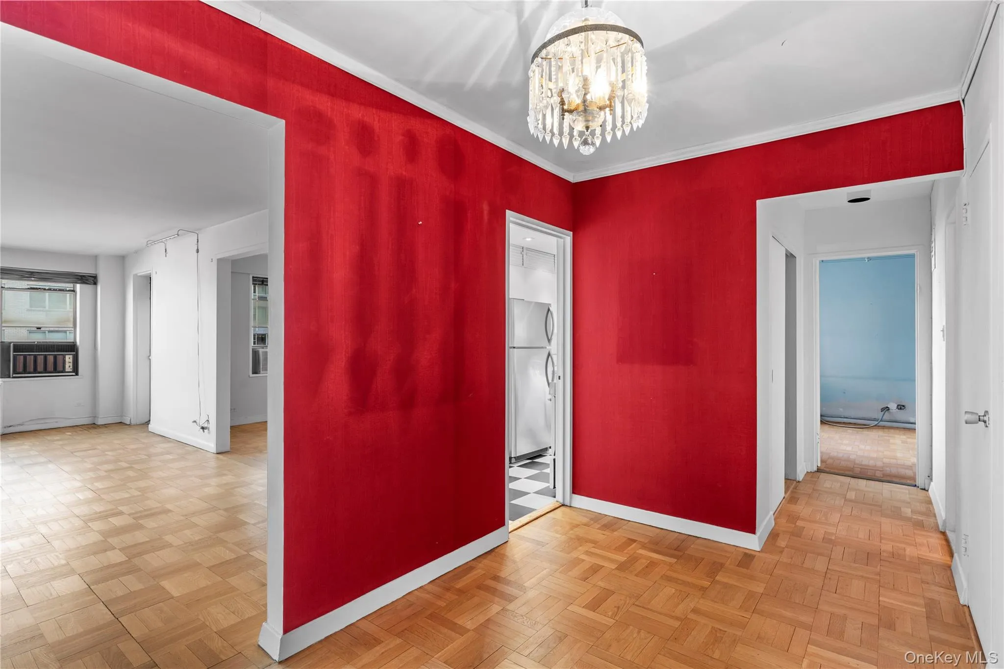Empty room featuring ornamental molding, baseboards, and a chandelier Empty room featuring ornamental molding, baseboards, and a chandelier