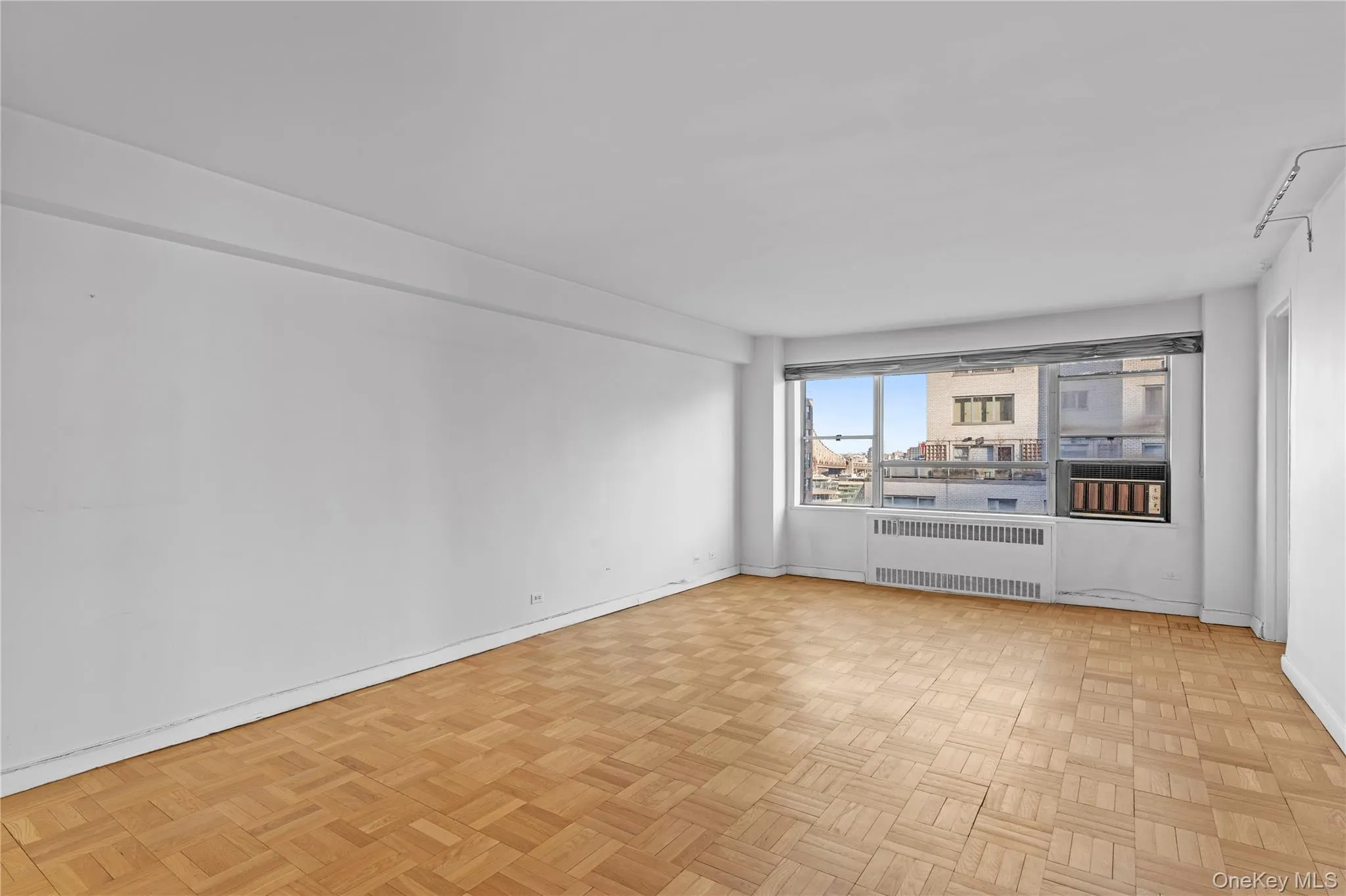 Unfurnished room featuring radiator and baseboards Unfurnished room featuring radiator and baseboards