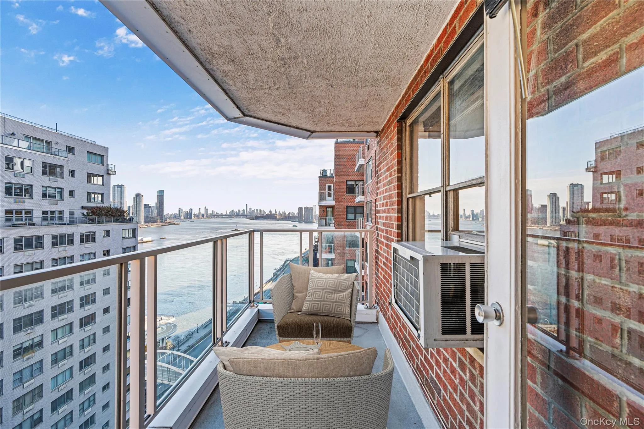 Balcony with a view of city and a water view Balcony with a view of city and a water view