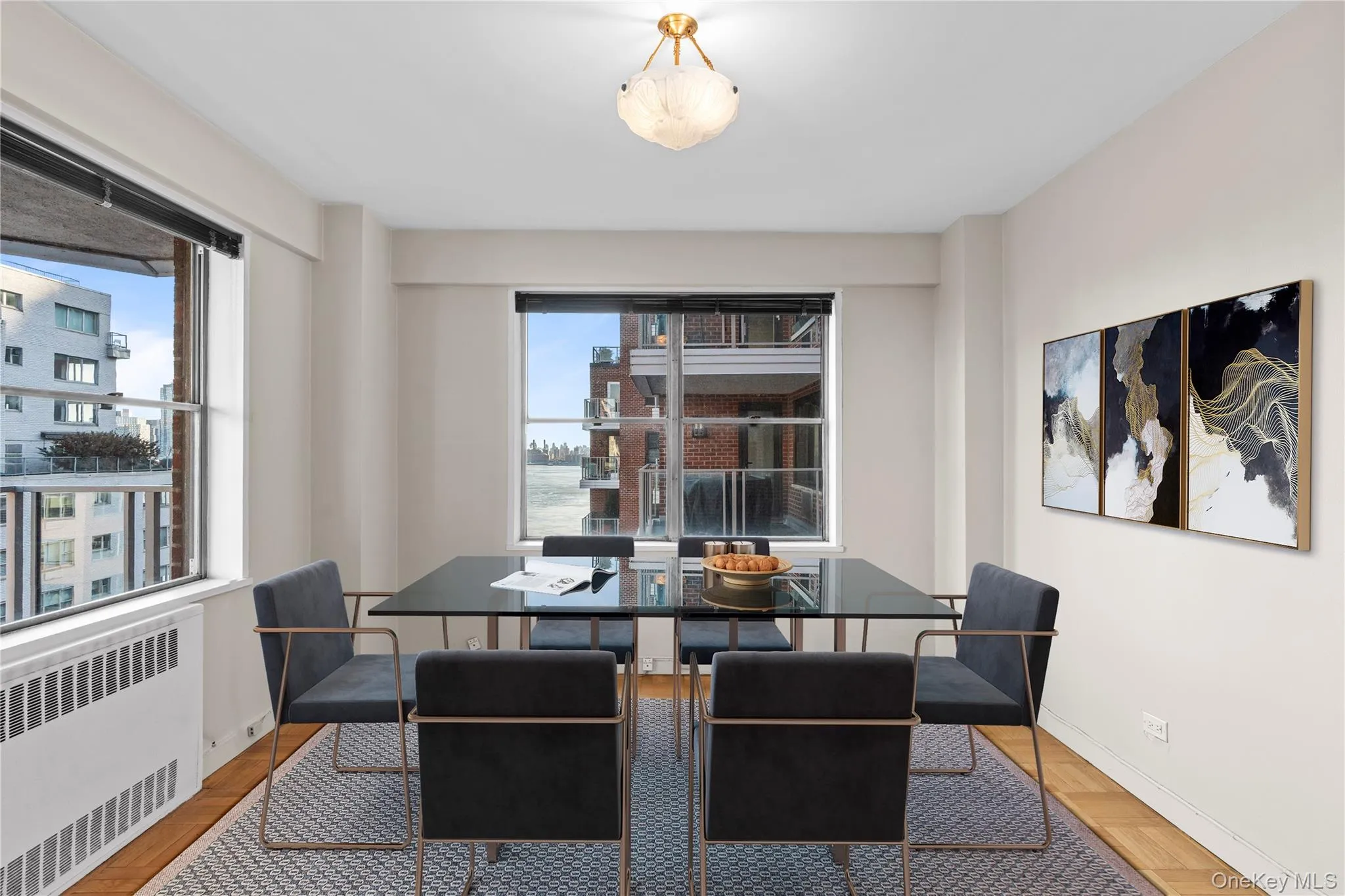Dining space featuring baseboards, plenty of natural light, and radiator heating unit Dining space featuring baseboards, plenty of natural light, and radiator heating unit