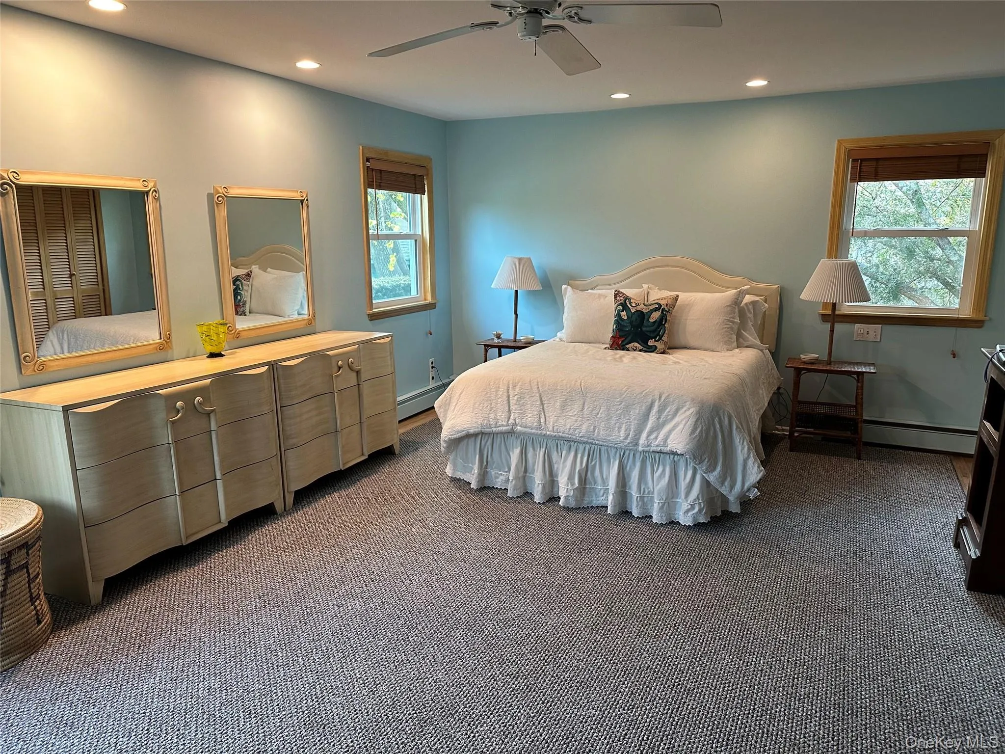 Bedroom featuring a baseboard heating unit, recessed lighting, carpet flooring, and baseboards Bedroom featuring a baseboard heating unit, recessed lighting, carpet flooring, and baseboards