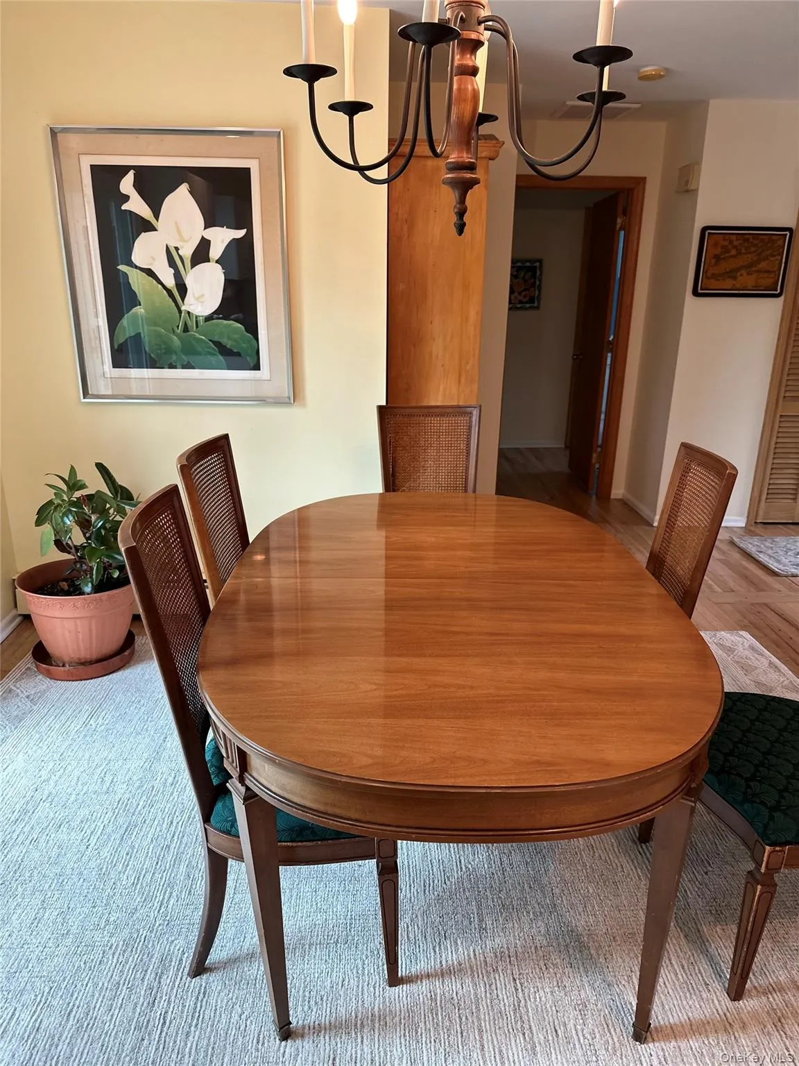 Dining area with a chandelier and baseboards Dining area with a chandelier and baseboards