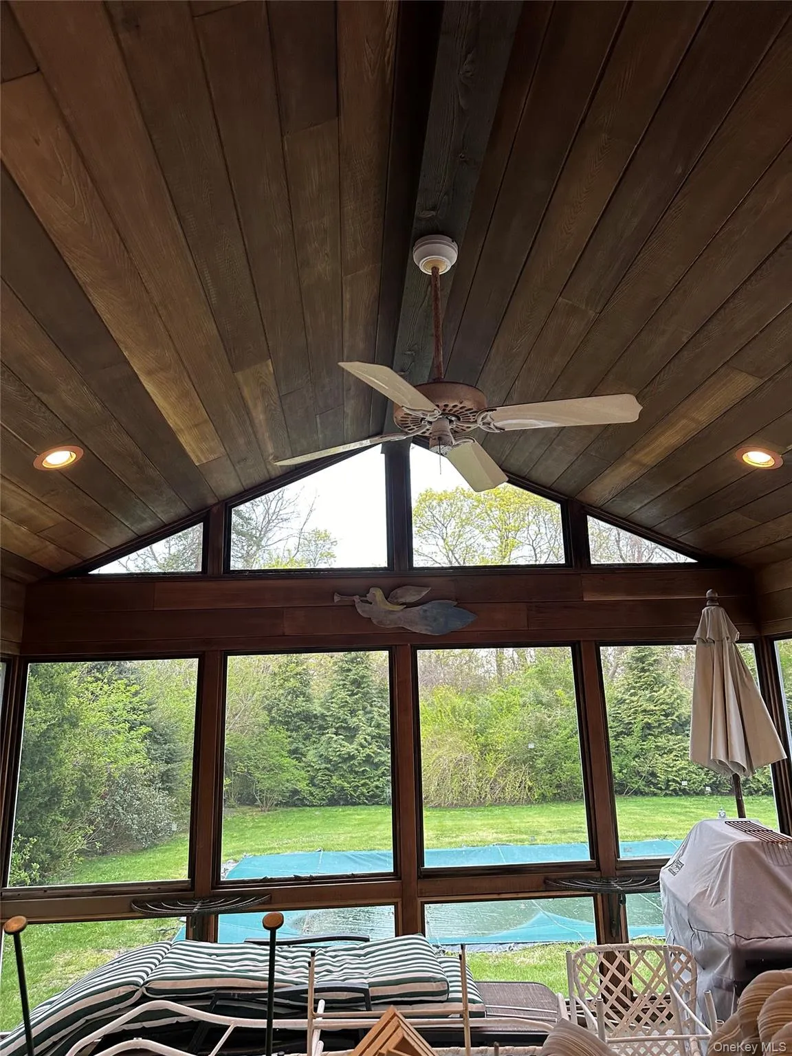 Sunroom with lofted ceiling, wooden ceiling, and a ceiling fan Sunroom with lofted ceiling, wooden ceiling, and a ceiling fan