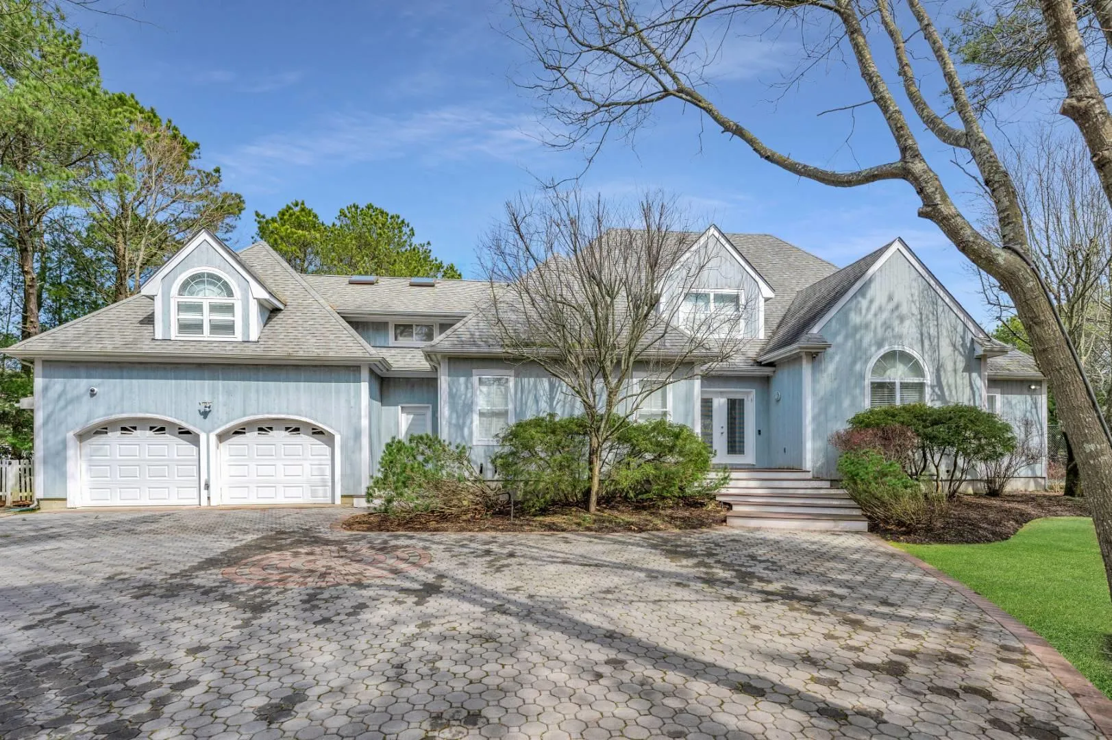 View of front of home featuring a garage, roof with shingles, decorative driveway, and french doors View of front of home featuring a garage, roof with shingles, decorative driveway, and french doors