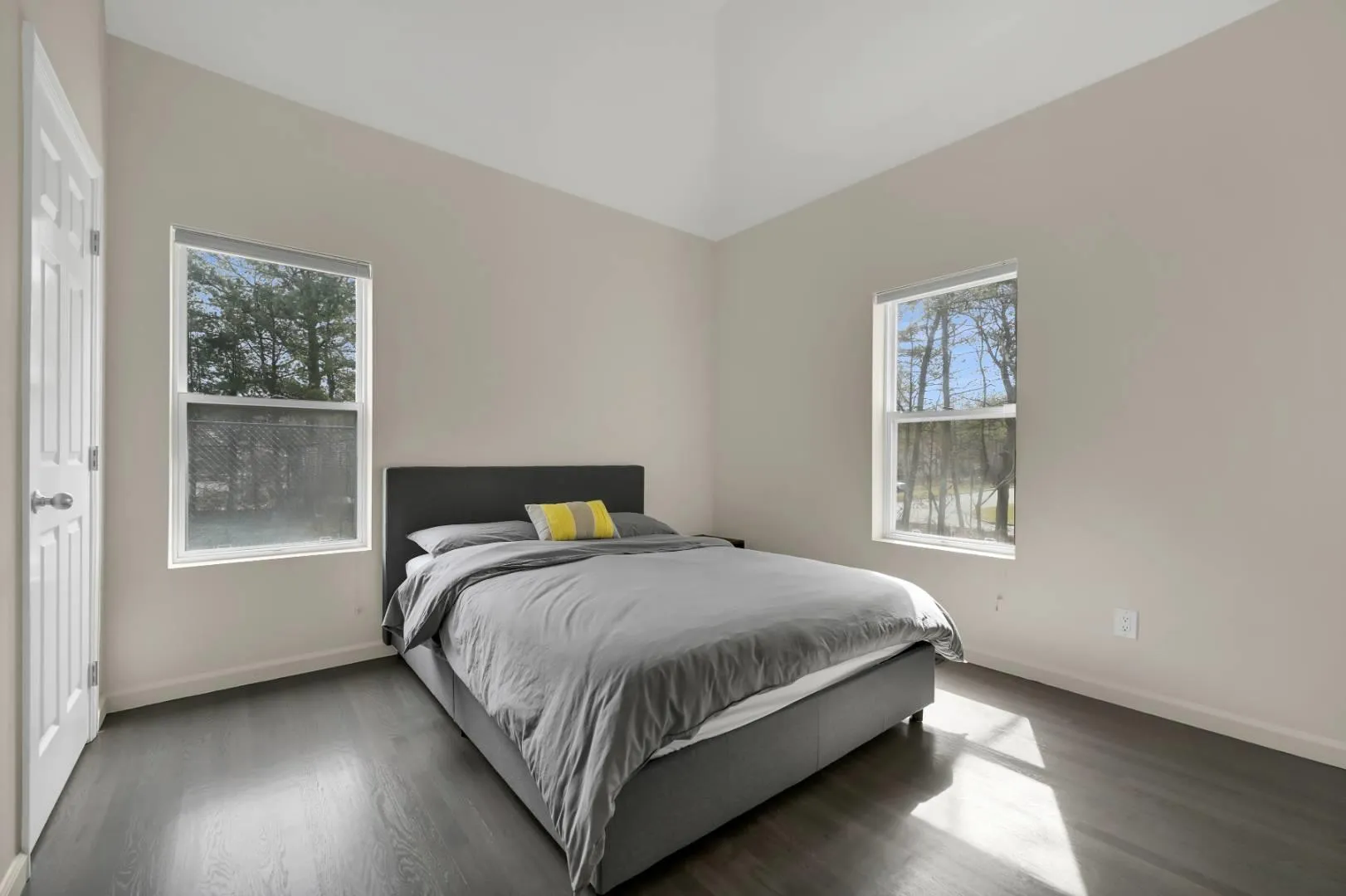Bedroom featuring baseboards and wood finished floors Bedroom featuring baseboards and wood finished floors