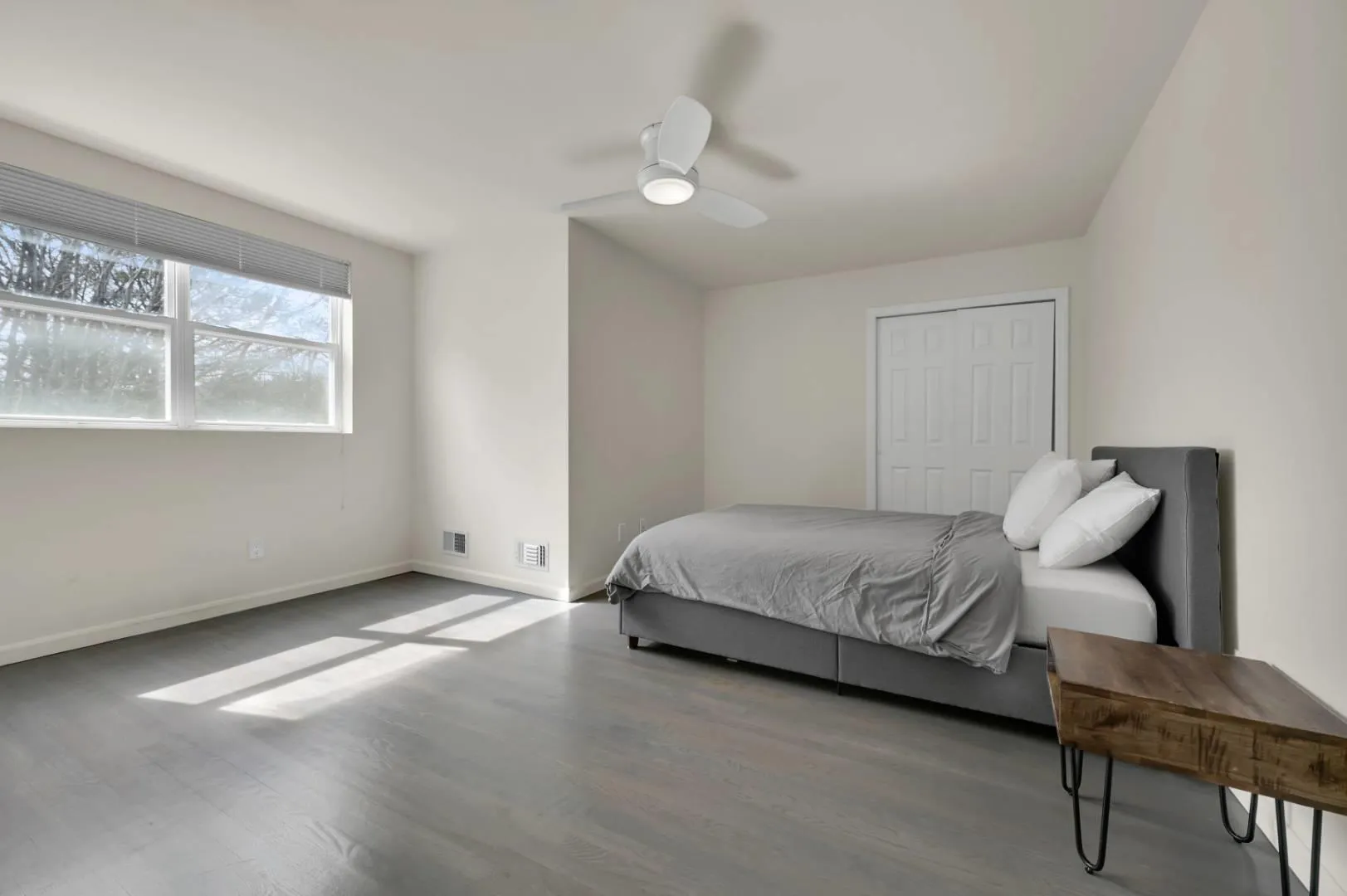 Bedroom featuring ceiling fan, a closet, baseboards, and wood finished floors Bedroom featuring ceiling fan, a closet, baseboards, and wood finished floors