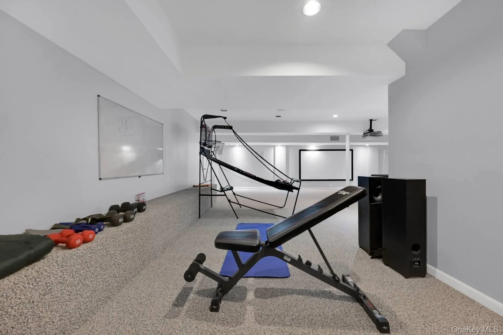 Exercise room with carpet floors, recessed lighting, and baseboards Exercise room with carpet floors, recessed lighting, and baseboards