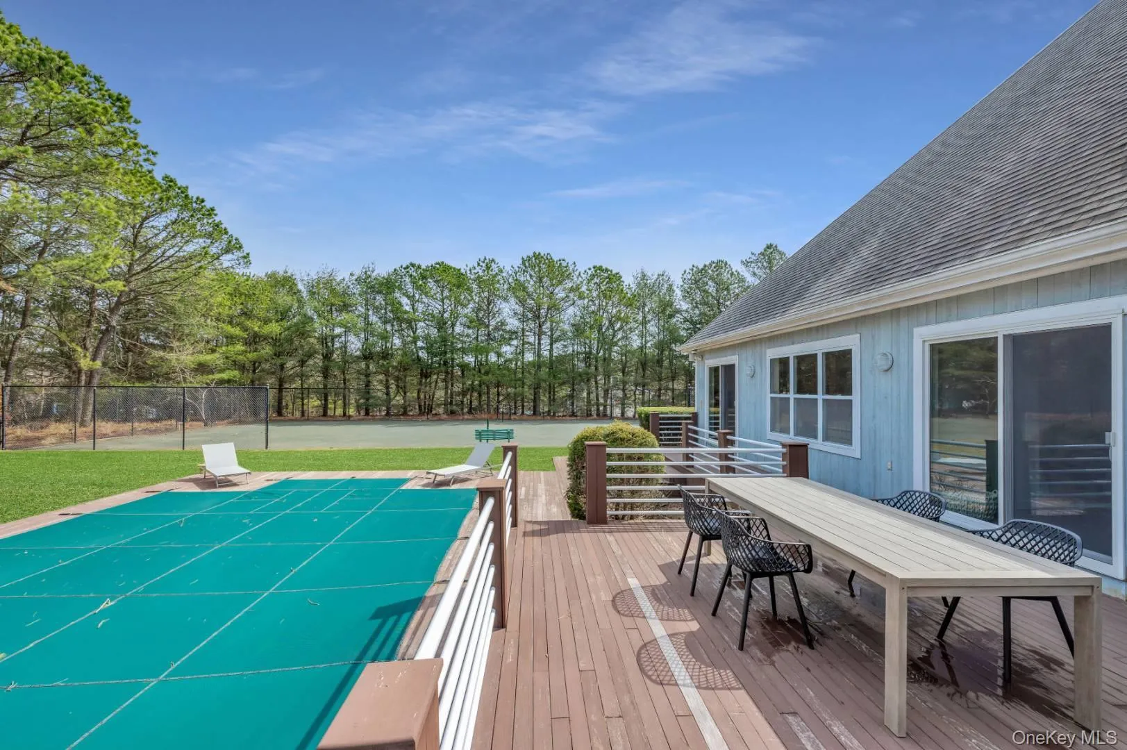 Deck featuring outdoor dining space, a lawn, and fence Deck featuring outdoor dining space, a lawn, and fence