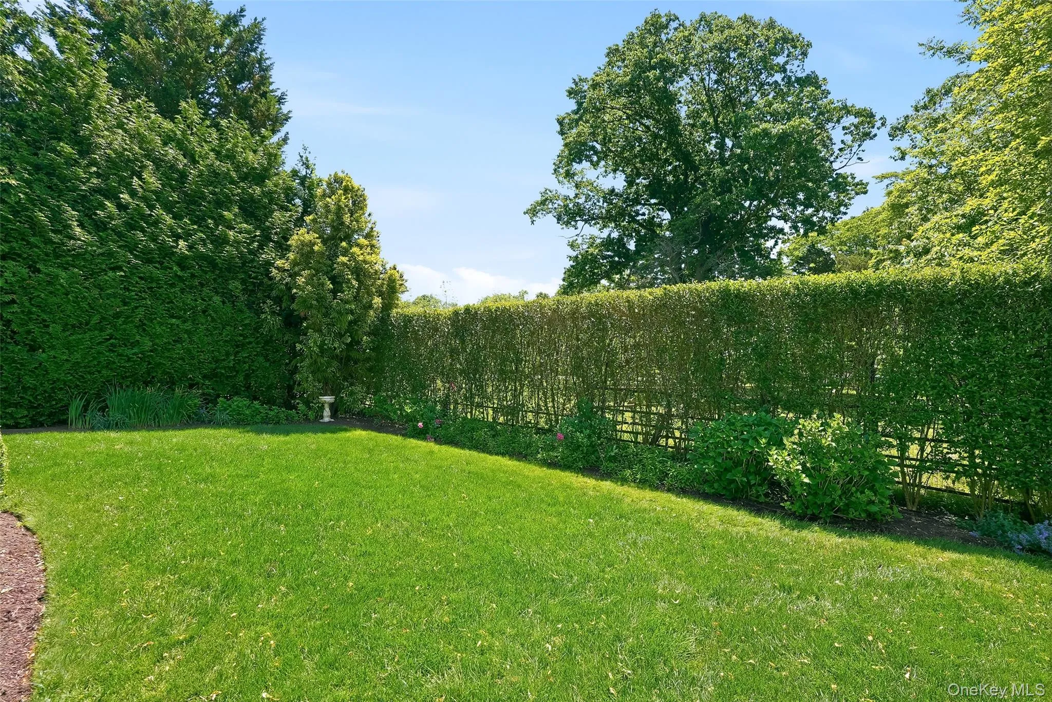 Level professionally landscaped yard designed so something is always in bloom. Level professionally landscaped yard designed so something is always in bloom.