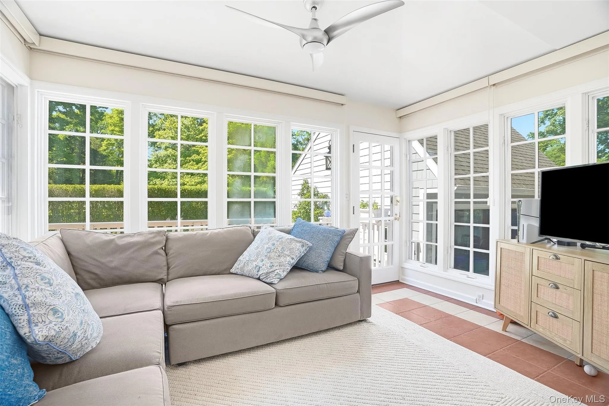Sun Room with 3 walls of windows and door to access the back deck and garage Sun Room with 3 walls of windows and door to access the back deck and garage