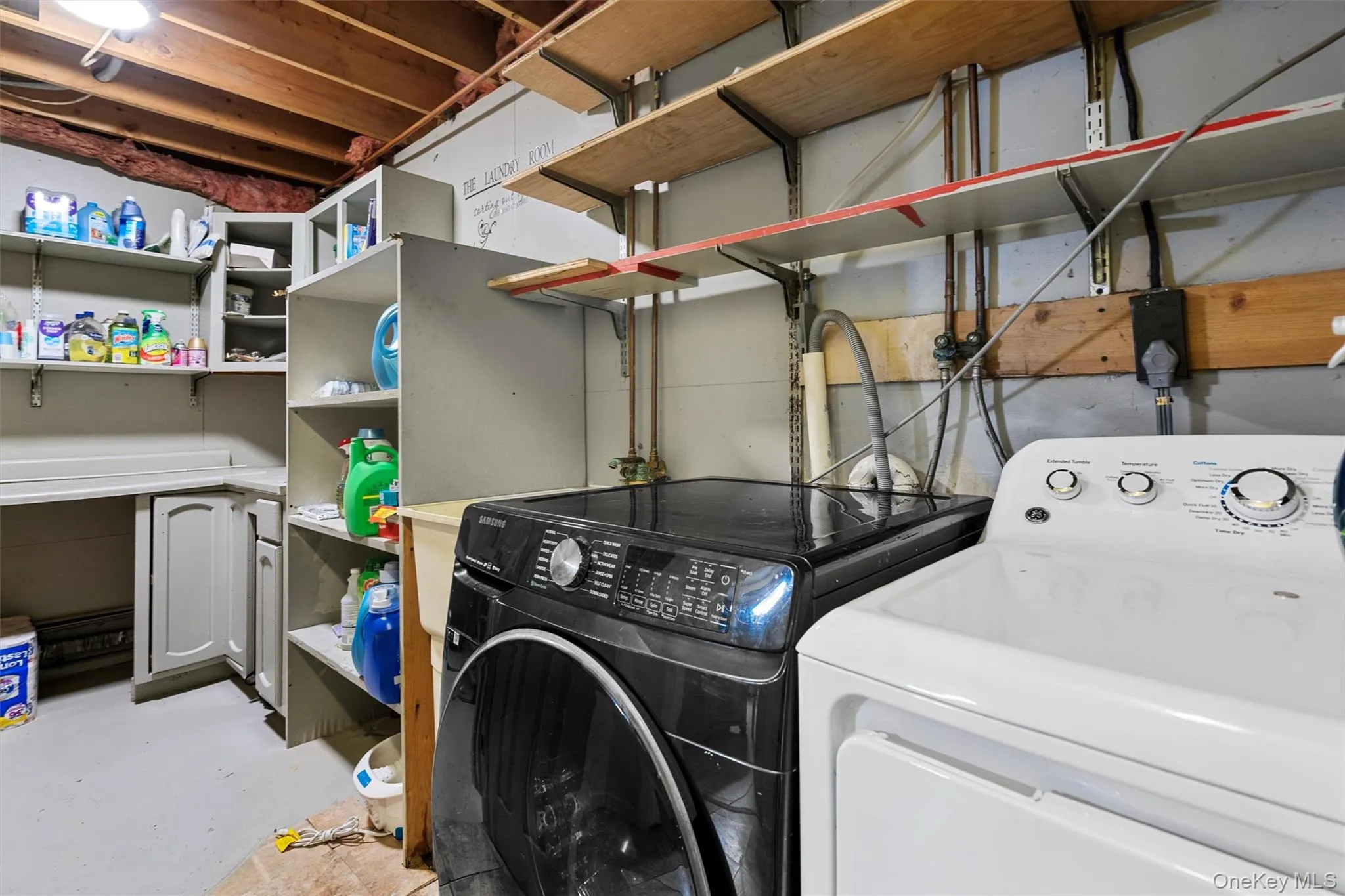 Laundry room featuring laundry area and washing machine and dryer Laundry room featuring laundry area and washing machine and dryer