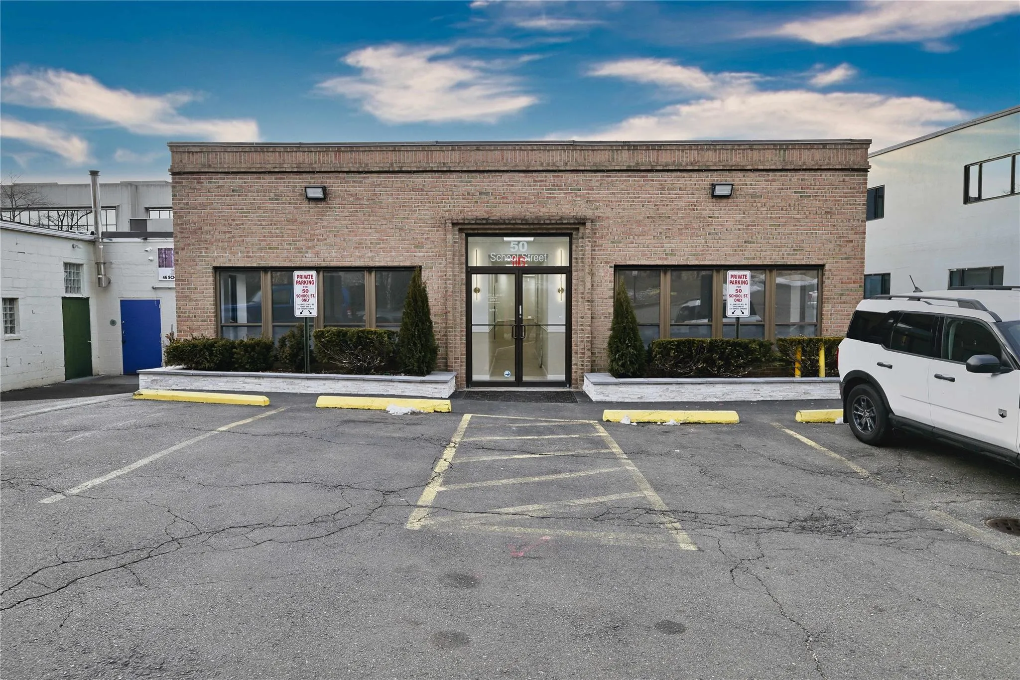 View of building exterior with uncovered parking View of building exterior with uncovered parking