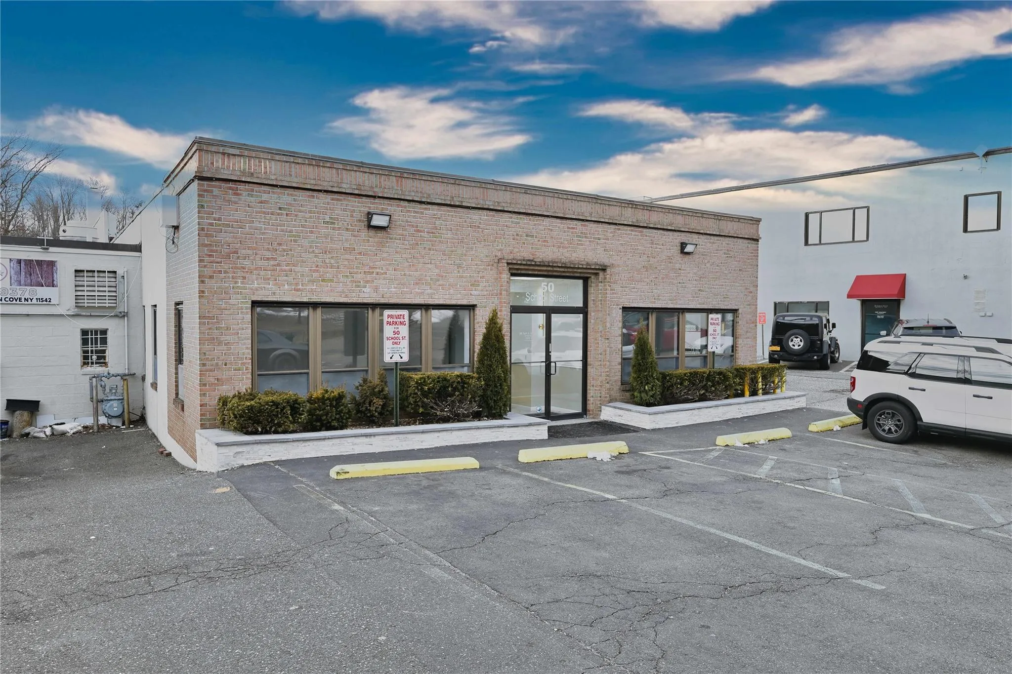 View of building exterior featuring uncovered parking View of building exterior featuring uncovered parking