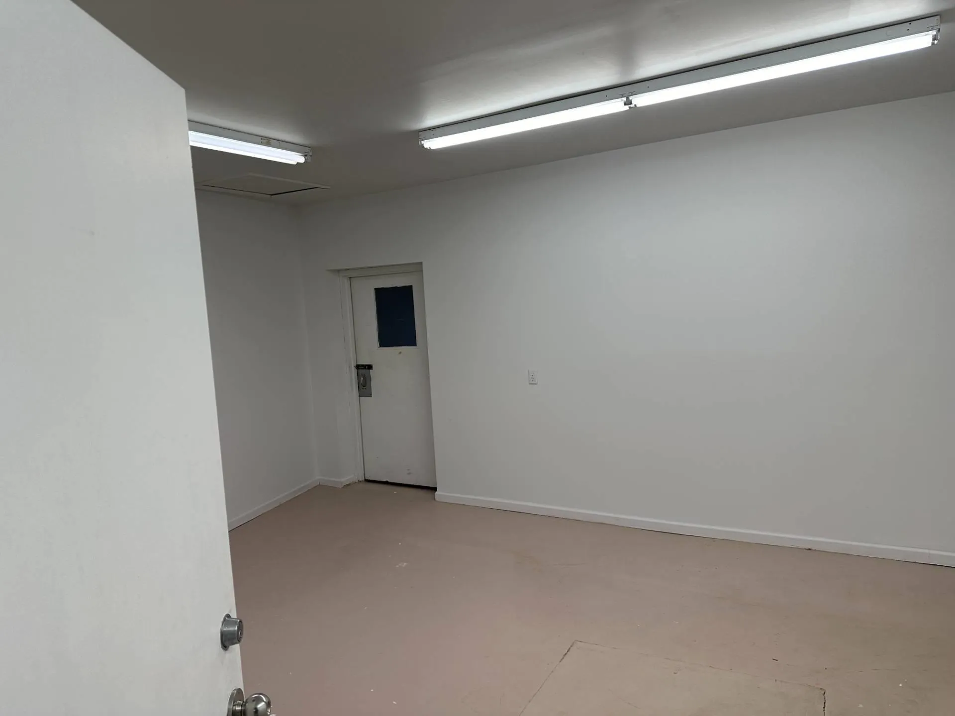 Unfurnished room with concrete floors and baseboards Unfurnished room with concrete floors and baseboards