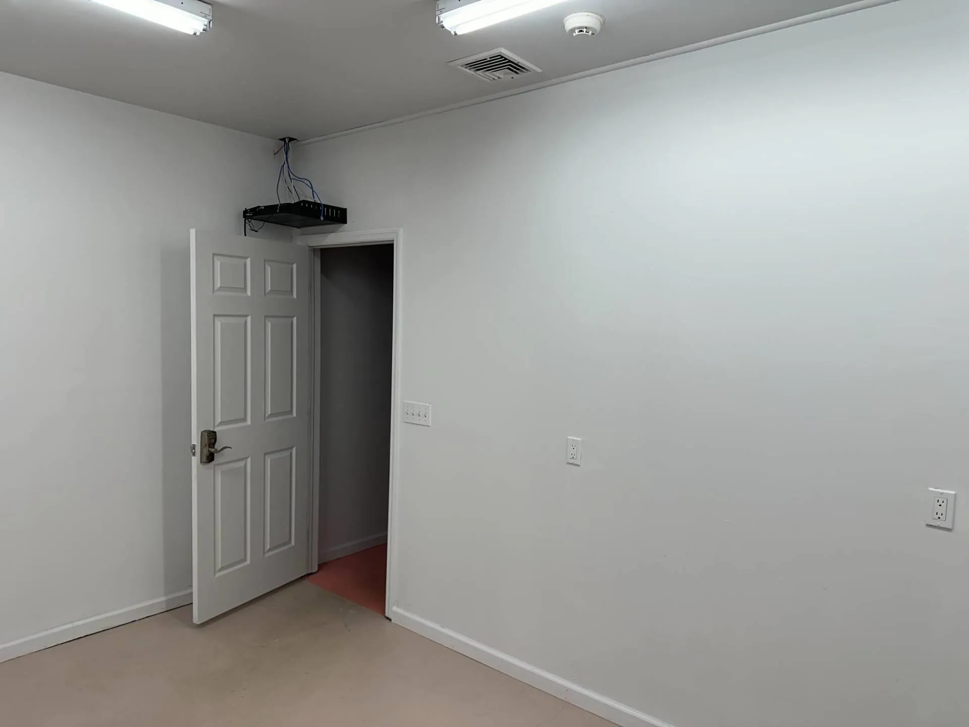 Empty room featuring visible vents, finished concrete flooring, and baseboards Empty room featuring visible vents, finished concrete flooring, and baseboards