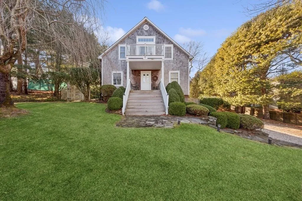 View of front of home featuring a balcony and a front yard View of front of home featuring a balcony and a front yard