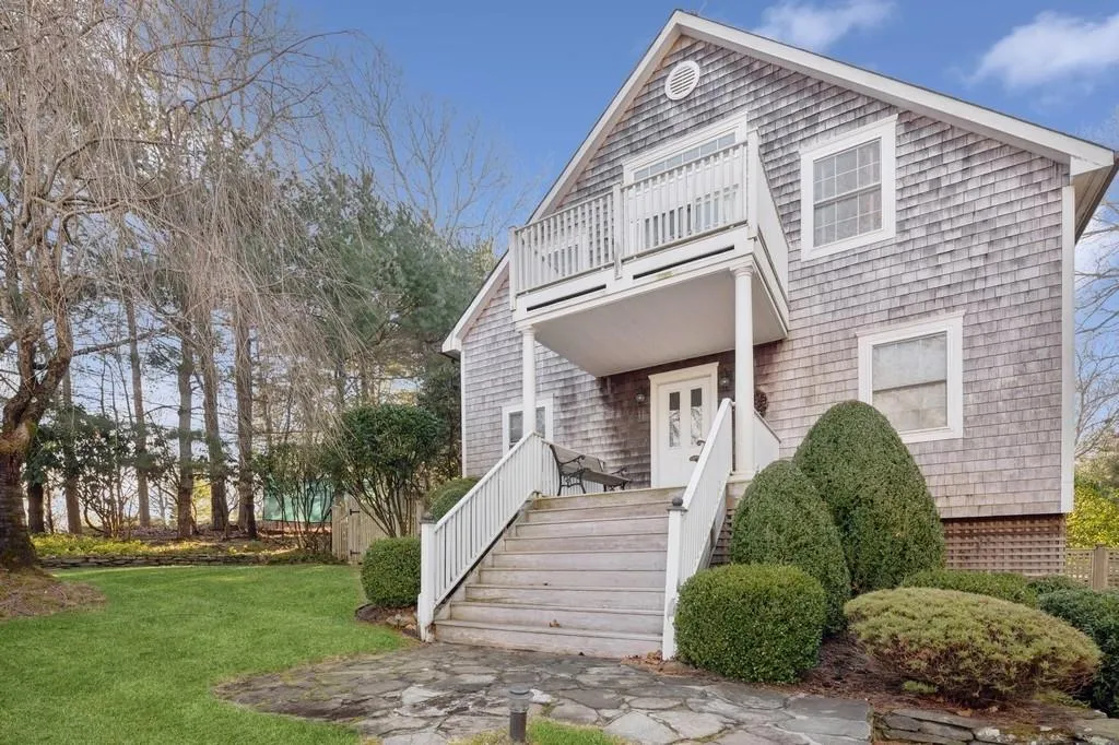 View of front of house with a balcony and a front lawn View of front of house with a balcony and a front lawn