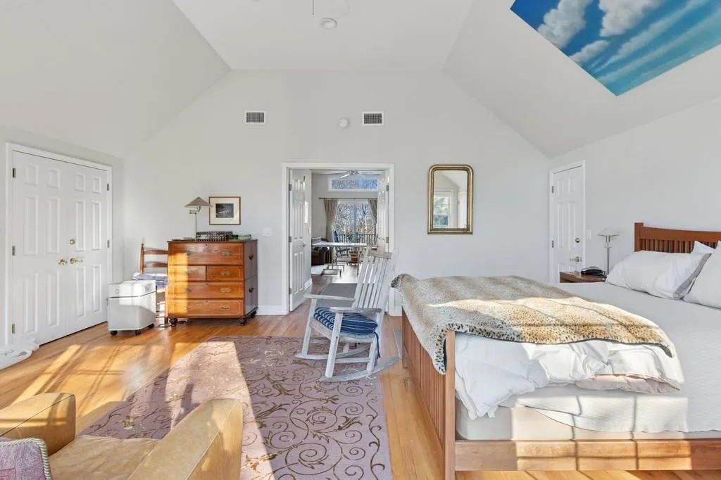 Bedroom featuring high vaulted ceiling, light wood-type flooring, and visible vents Bedroom featuring high vaulted ceiling, light wood-type flooring, and visible vents