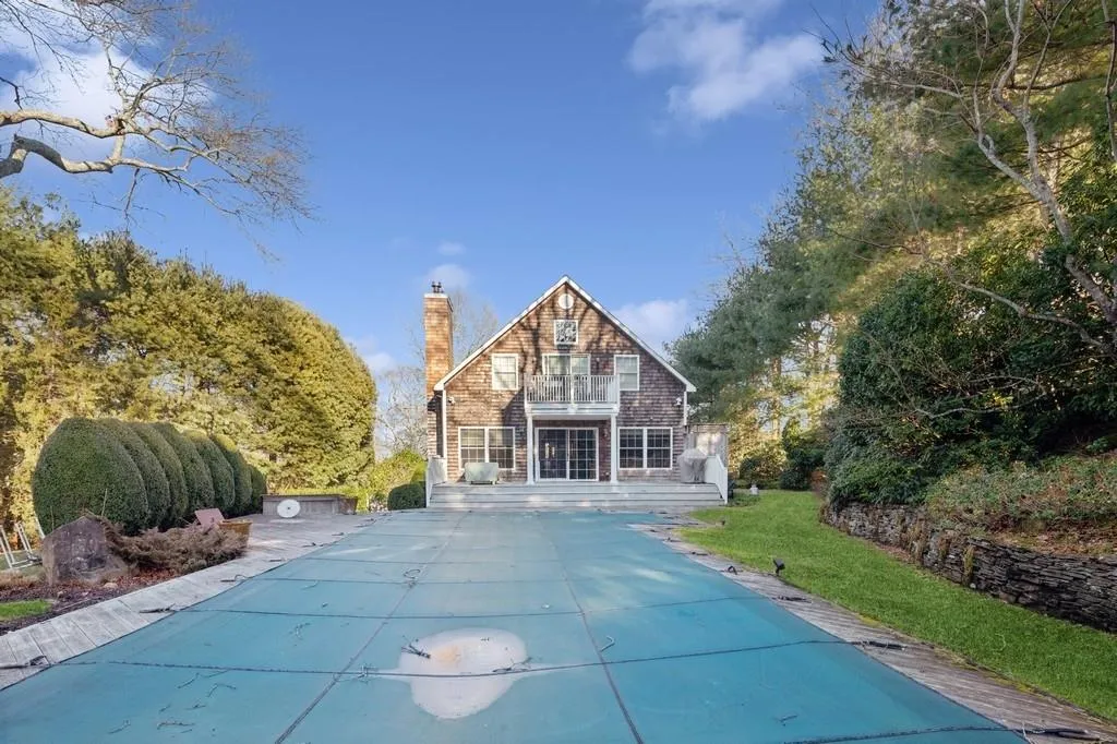 View of front facade with a chimney and a balcony View of front facade with a chimney and a balcony