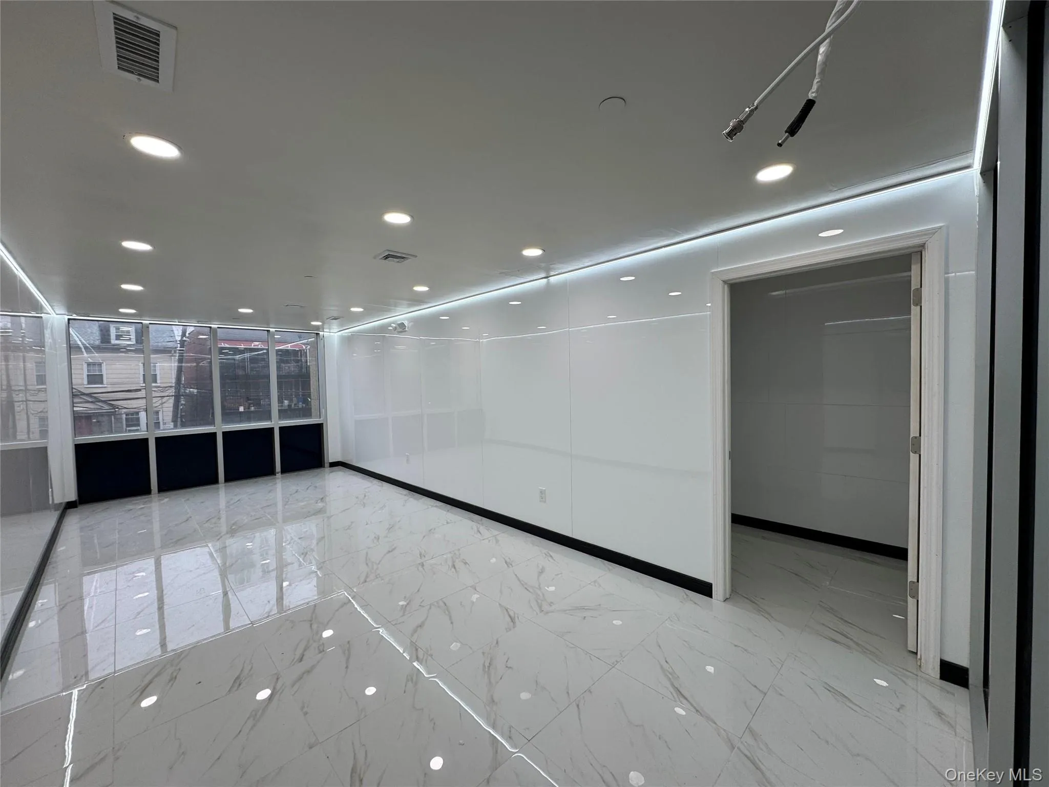 Empty room with marble finish floor, visible vents, and recessed lighting Empty room with marble finish floor, visible vents, and recessed lighting