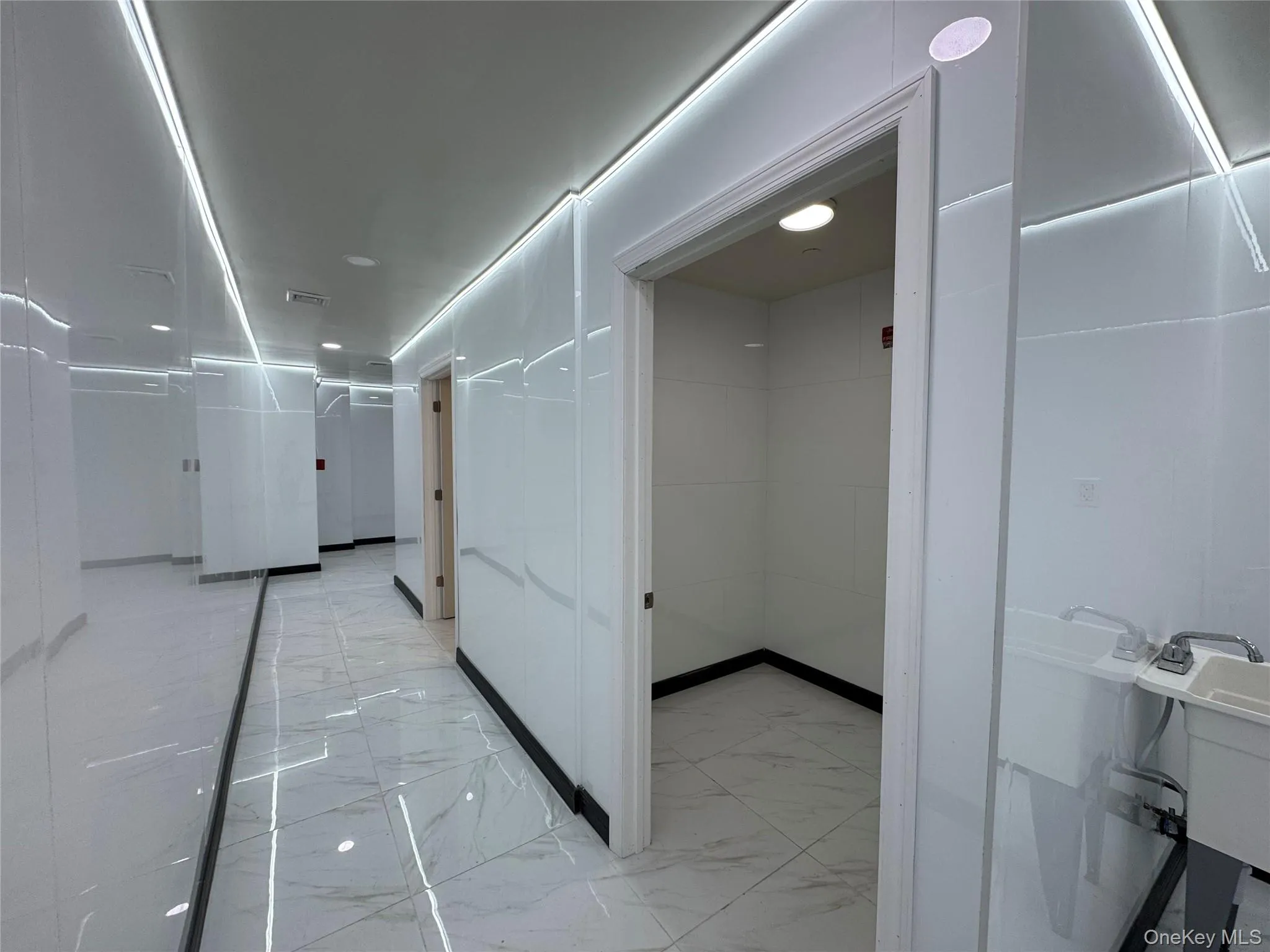 Corridor with marble finish floor and visible vents Corridor with marble finish floor and visible vents
