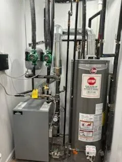 Utility room featuring a heating unit and water heater Utility room featuring a heating unit and water heater