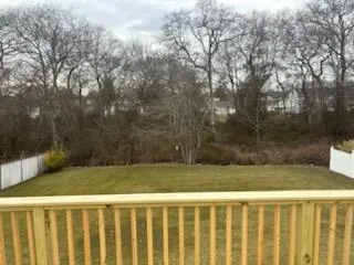 View of yard featuring fence and a deck View of yard featuring fence and a deck