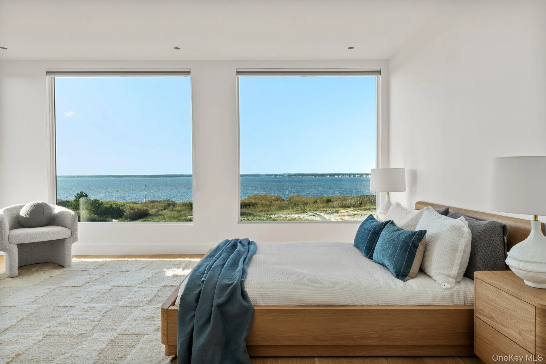 Bedroom with a water view and wood finished floors Bedroom with a water view and wood finished floors
