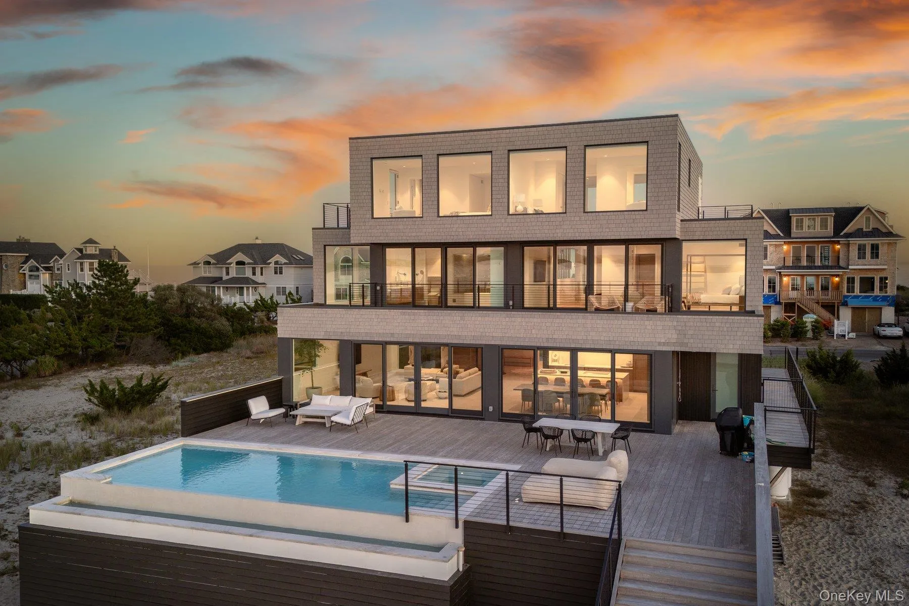 Back of property with outdoor dining area, a balcony, a deck, an outdoor pool, and an outdoor hangout area Back of property with outdoor dining area, a balcony, a deck, an outdoor pool, and an outdoor hangout area
