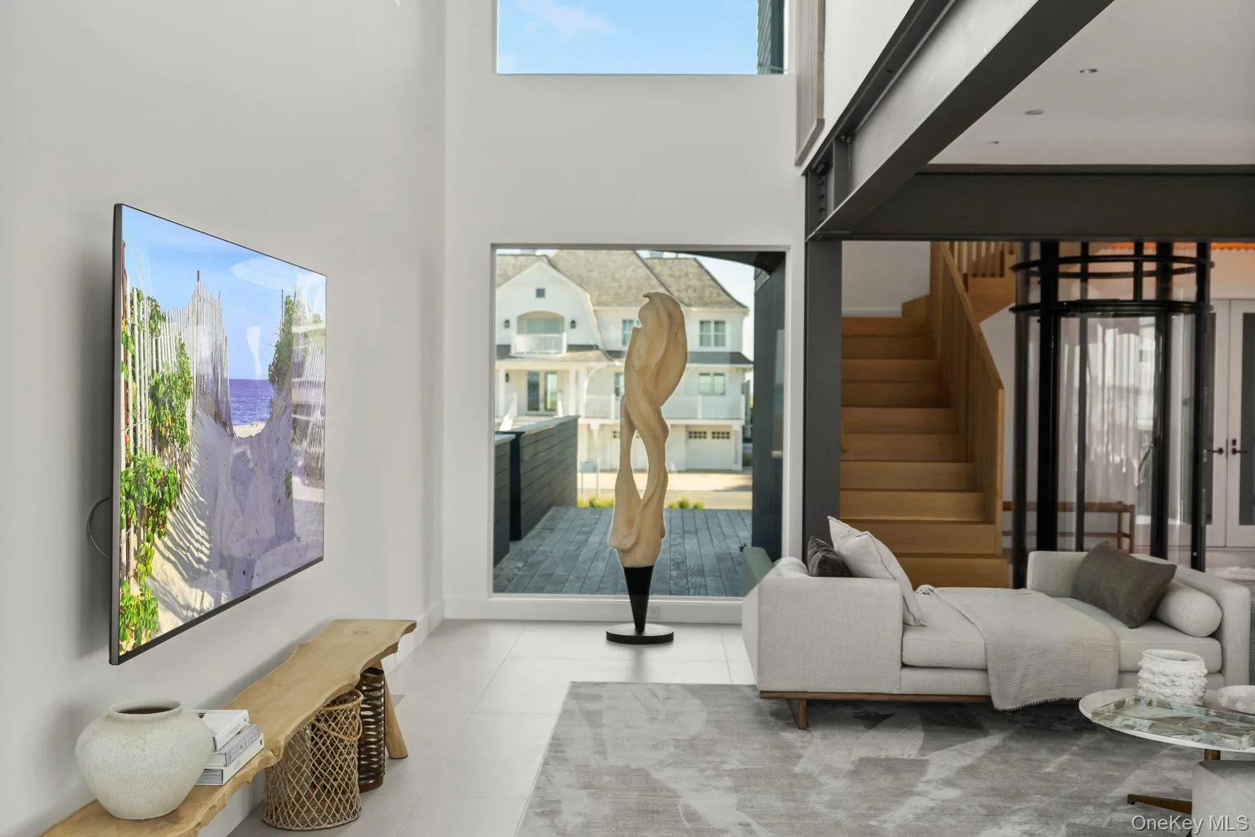 Sitting room with stairs, tile patterned flooring, and a towering ceiling Sitting room with stairs, tile patterned flooring, and a towering ceiling