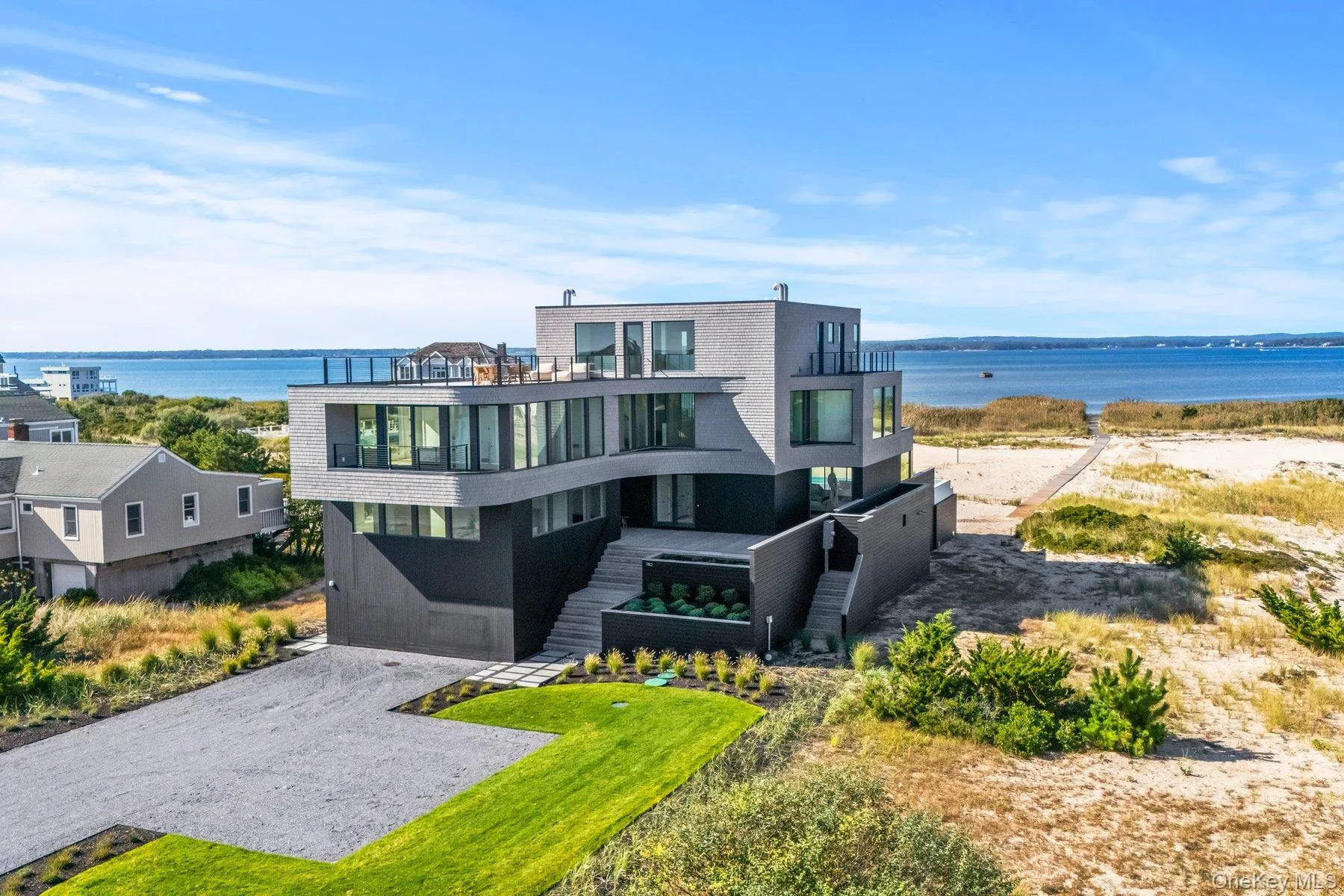 View of front of house with a balcony and a water view View of front of house with a balcony and a water view