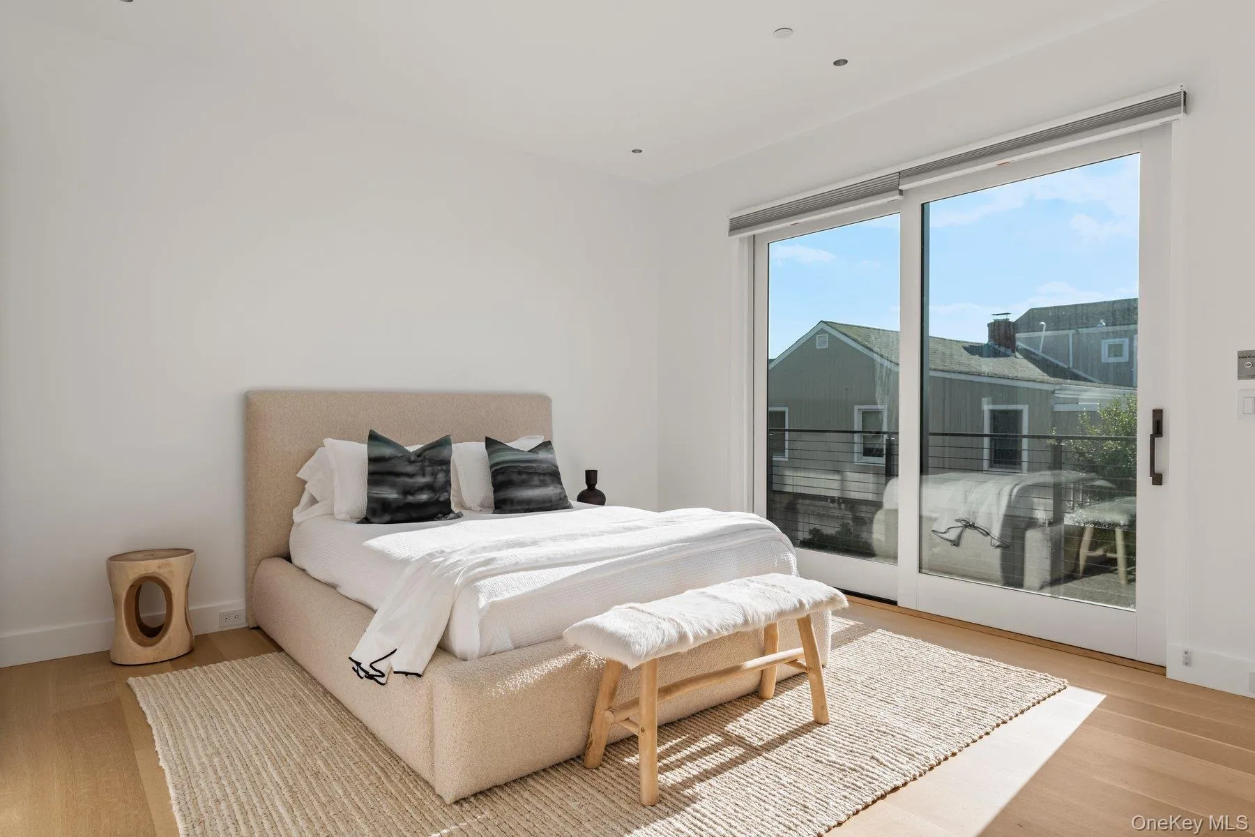 Bedroom featuring light wood finished floors and access to outside Bedroom featuring light wood finished floors and access to outside