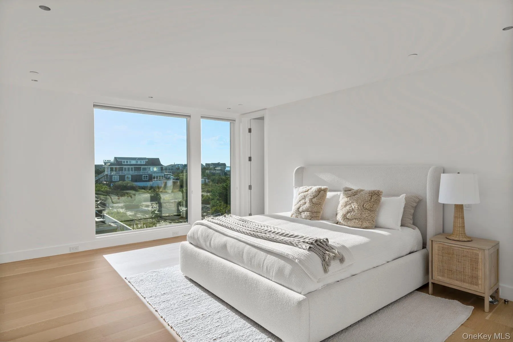 Bedroom featuring light wood-style flooring and baseboards Bedroom featuring light wood-style flooring and baseboards
