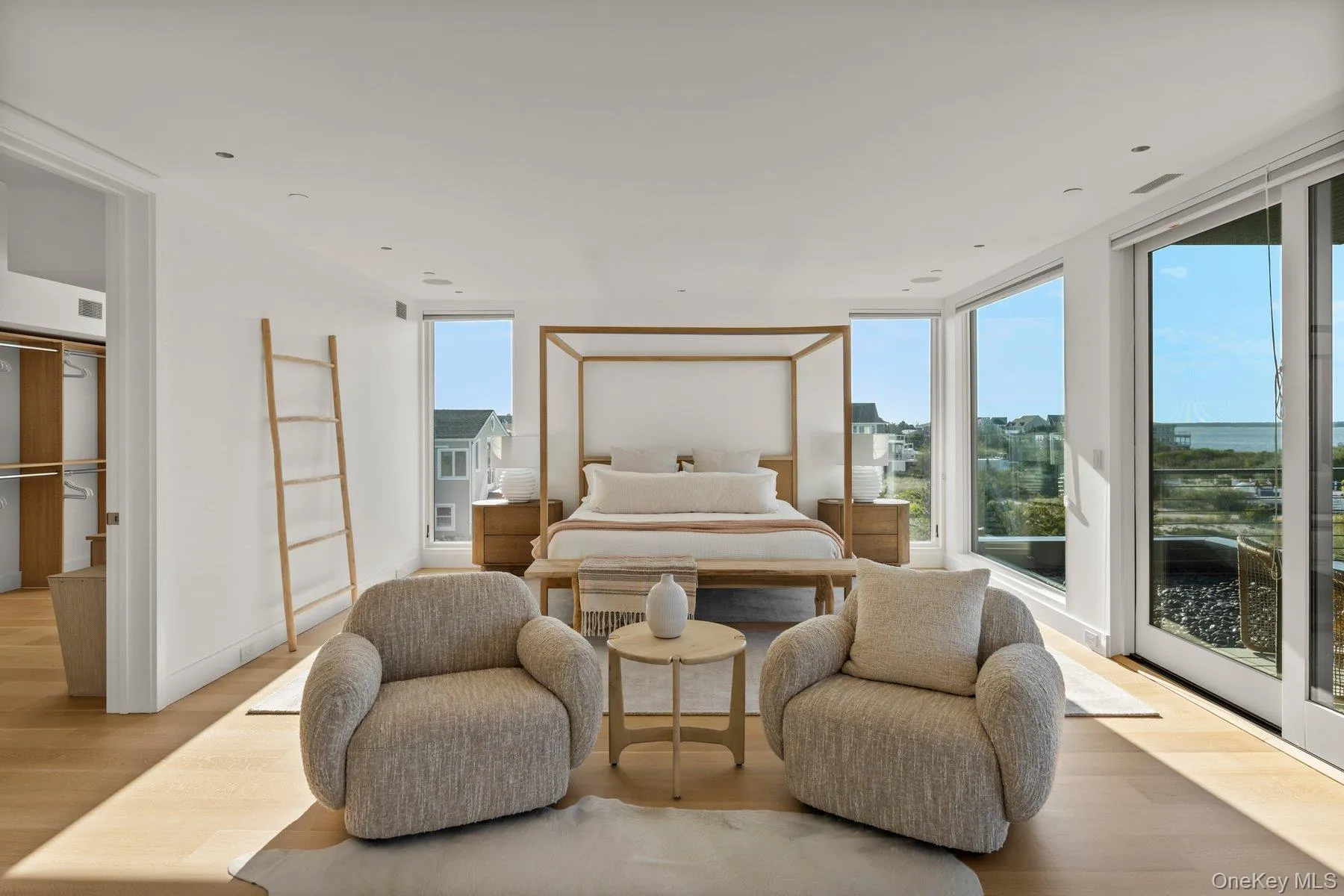Bedroom with wood finished floors, access to outside, and floor to ceiling windows Bedroom with wood finished floors, access to outside, and floor to ceiling windows