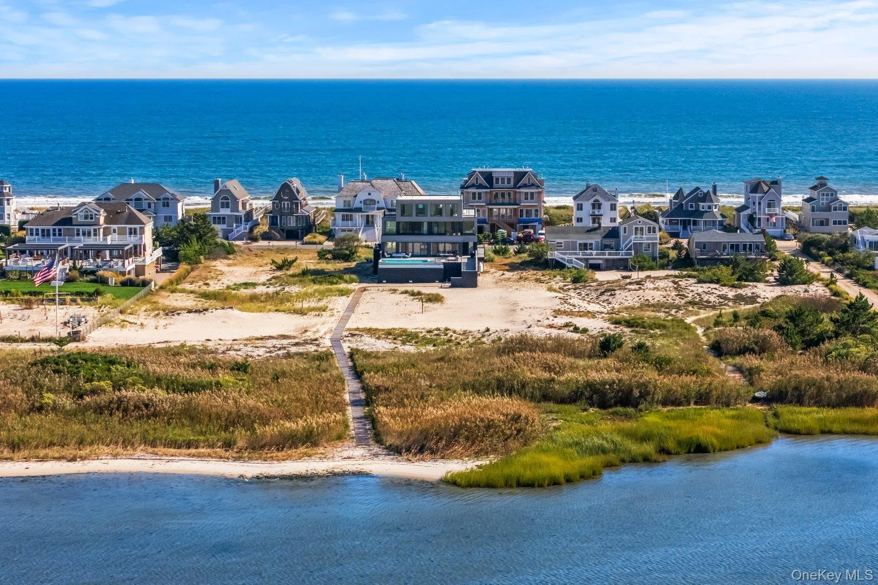 Aerial view of residential area featuring a large body of water Aerial view of residential area featuring a large body of water