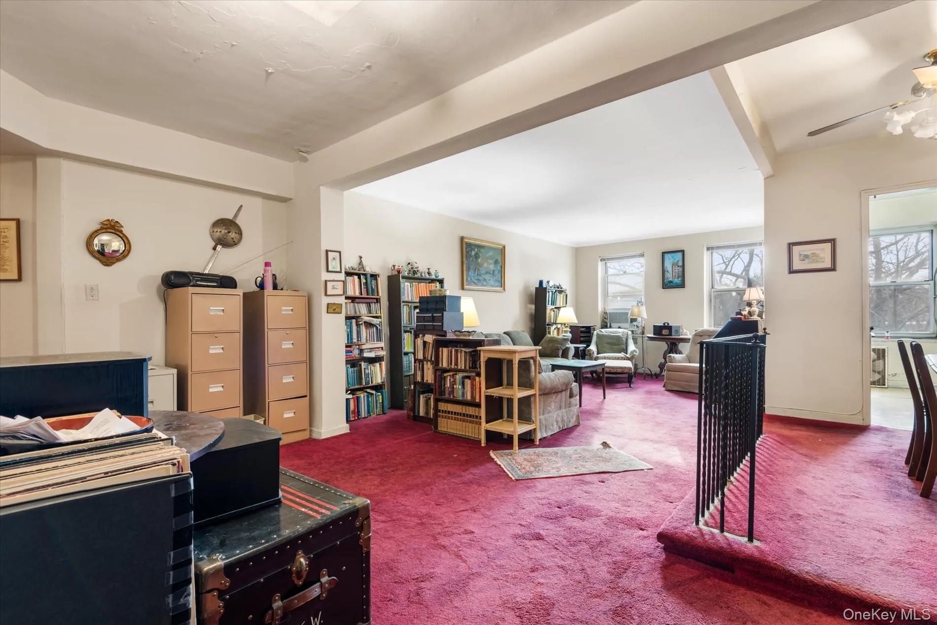 Office space with a wealth of natural light, carpet flooring, and baseboards Office space with a wealth of natural light, carpet flooring, and baseboards