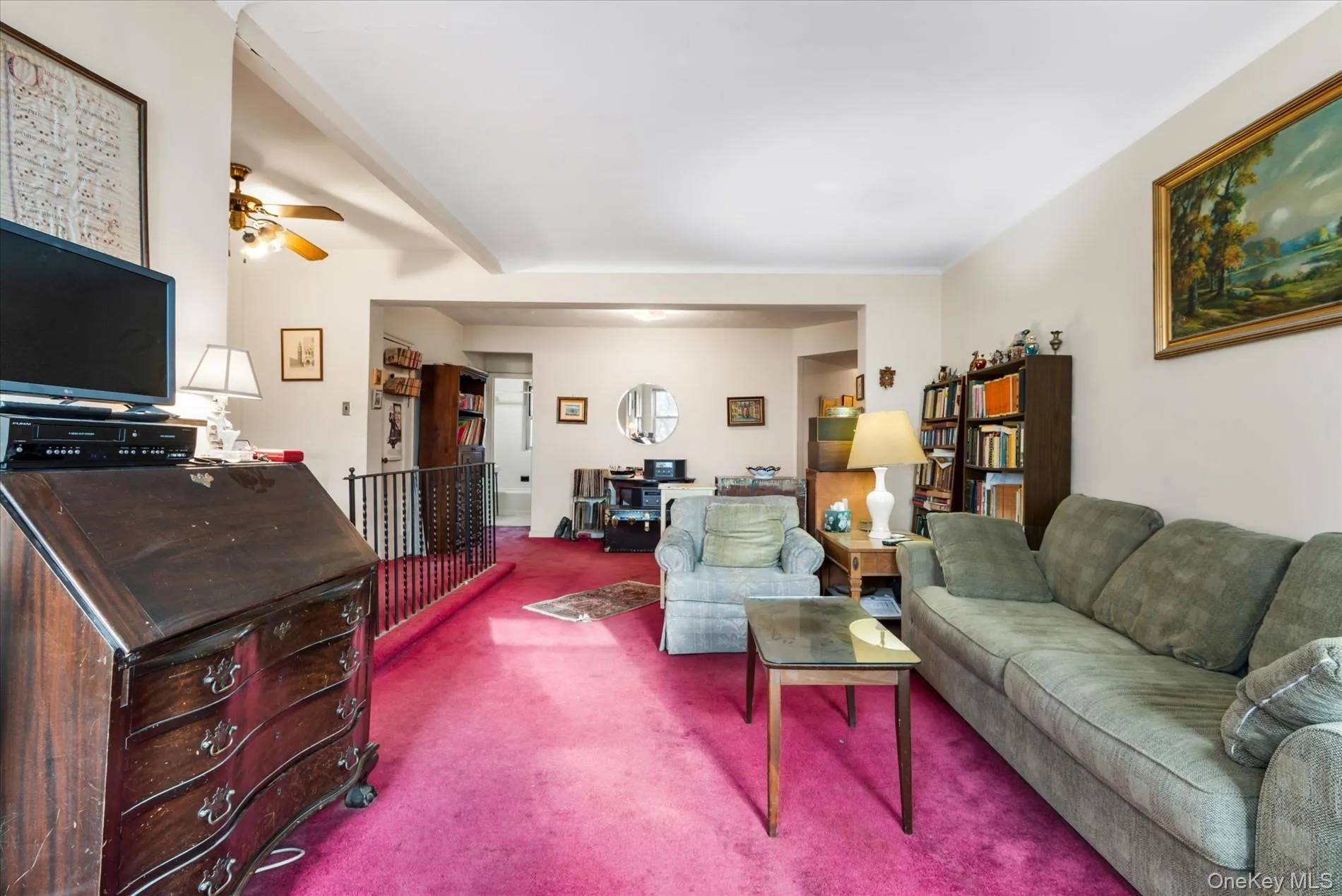 Living area with ceiling fan and carpet floors Living area with ceiling fan and carpet floors