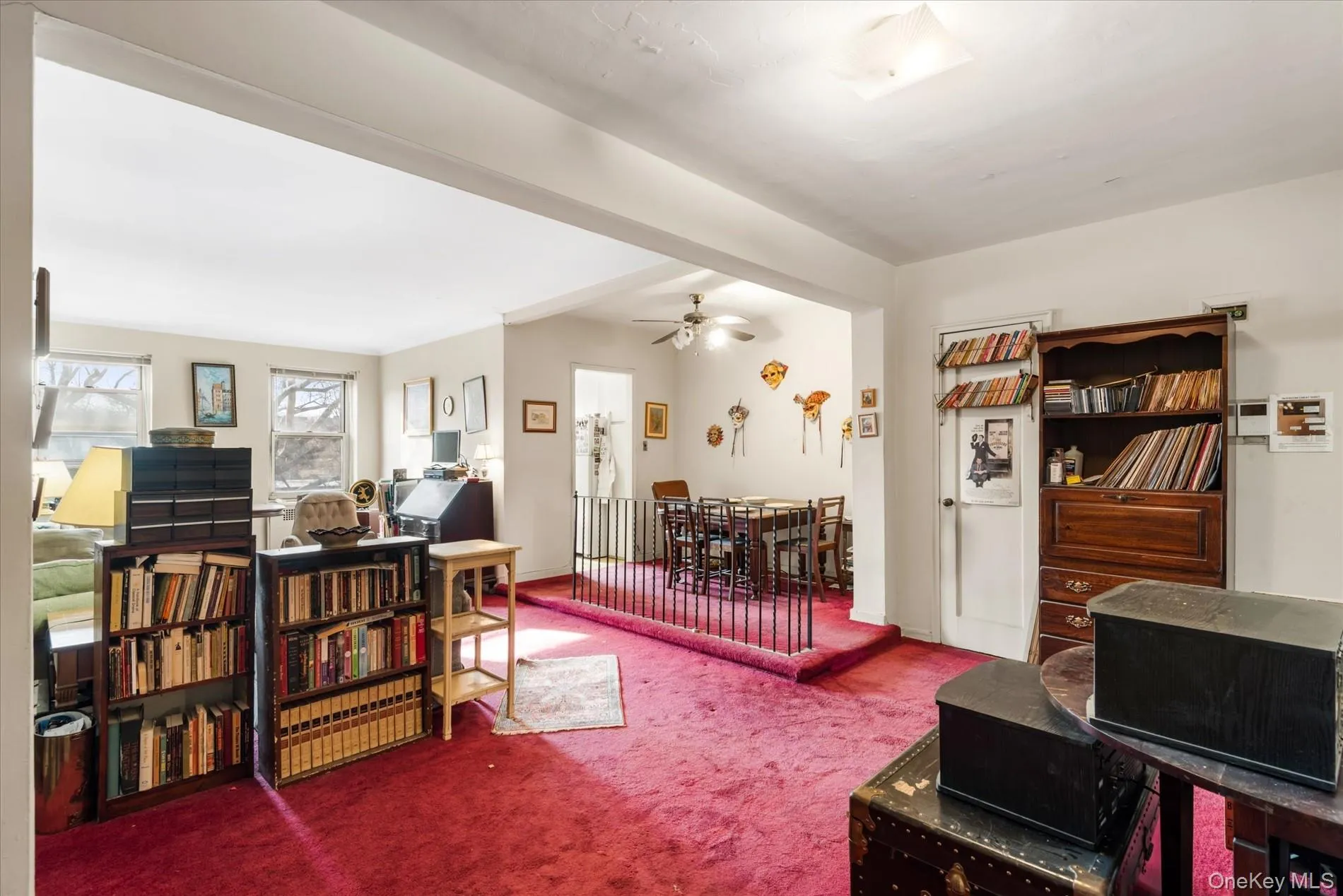 Living area featuring ceiling fan and carpet floors Living area featuring ceiling fan and carpet floors