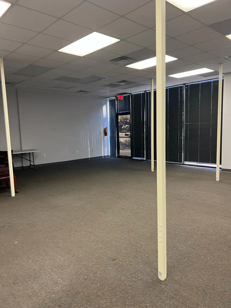 Basement featuring carpet floors, a drop ceiling, visible vents, and baseboards Basement featuring carpet floors, a drop ceiling, visible vents, and baseboards