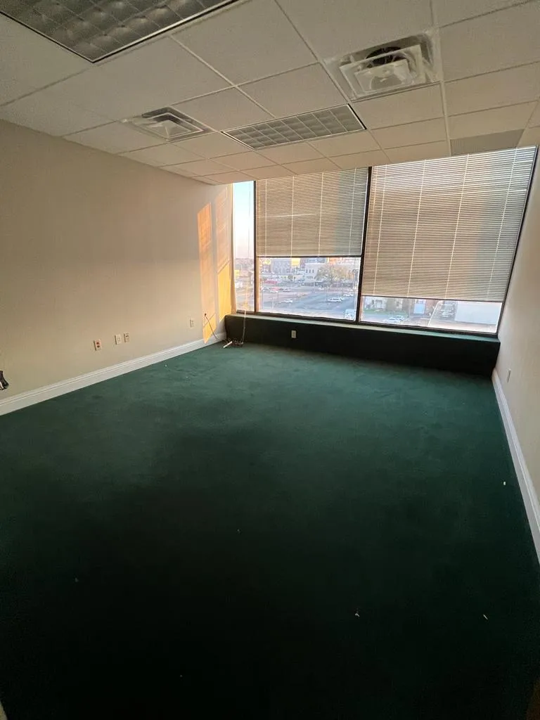 Carpeted empty room featuring a paneled ceiling, visible vents, and baseboards Carpeted empty room featuring a paneled ceiling, visible vents, and baseboards