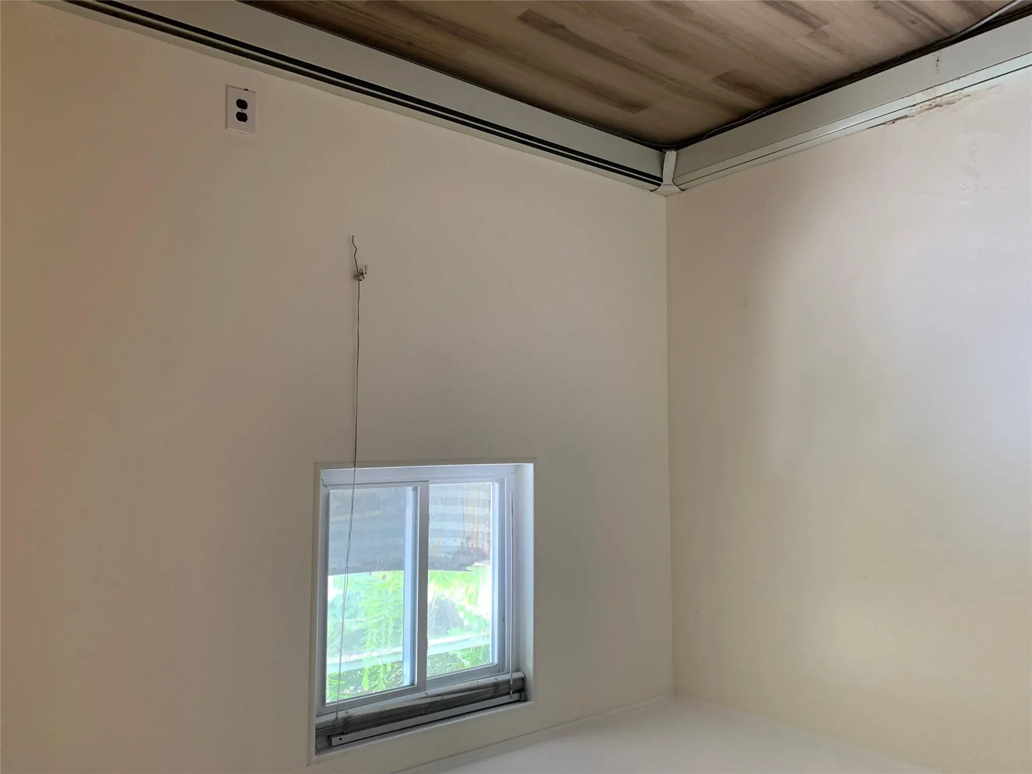 Empty room with a baseboard heating unit and light wood-style floors Empty room with a baseboard heating unit and light wood-style floors