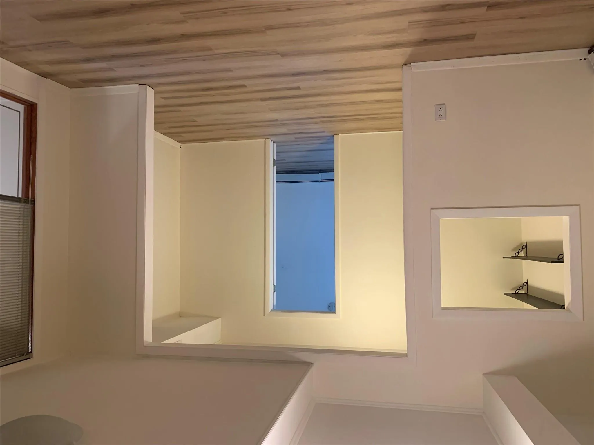 Hallway with a baseboard heating unit, light wood-style flooring, and crown molding Hallway with a baseboard heating unit, light wood-style flooring, and crown molding