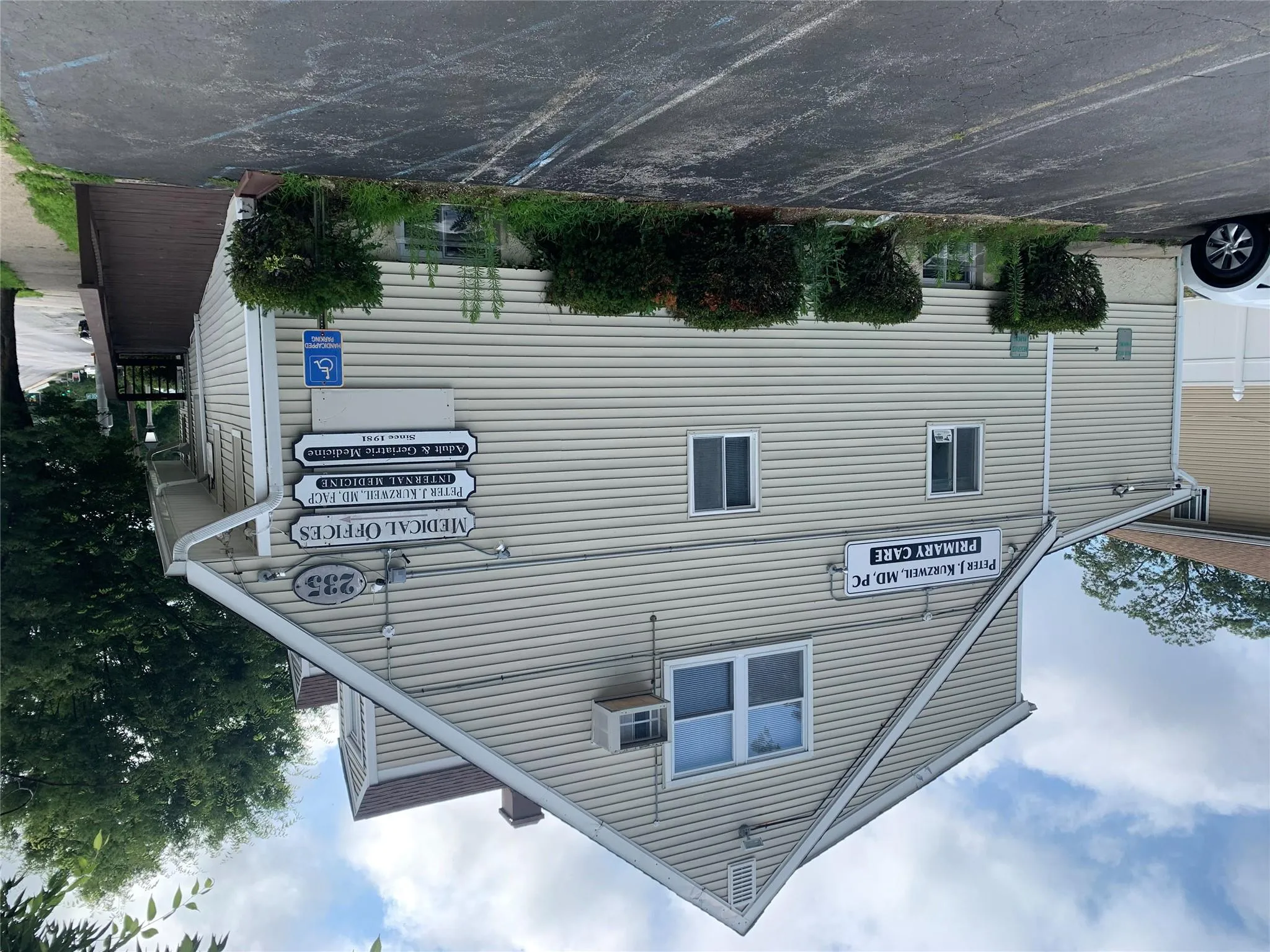 View of property exterior featuring uncovered parking and a chimney View of property exterior featuring uncovered parking and a chimney