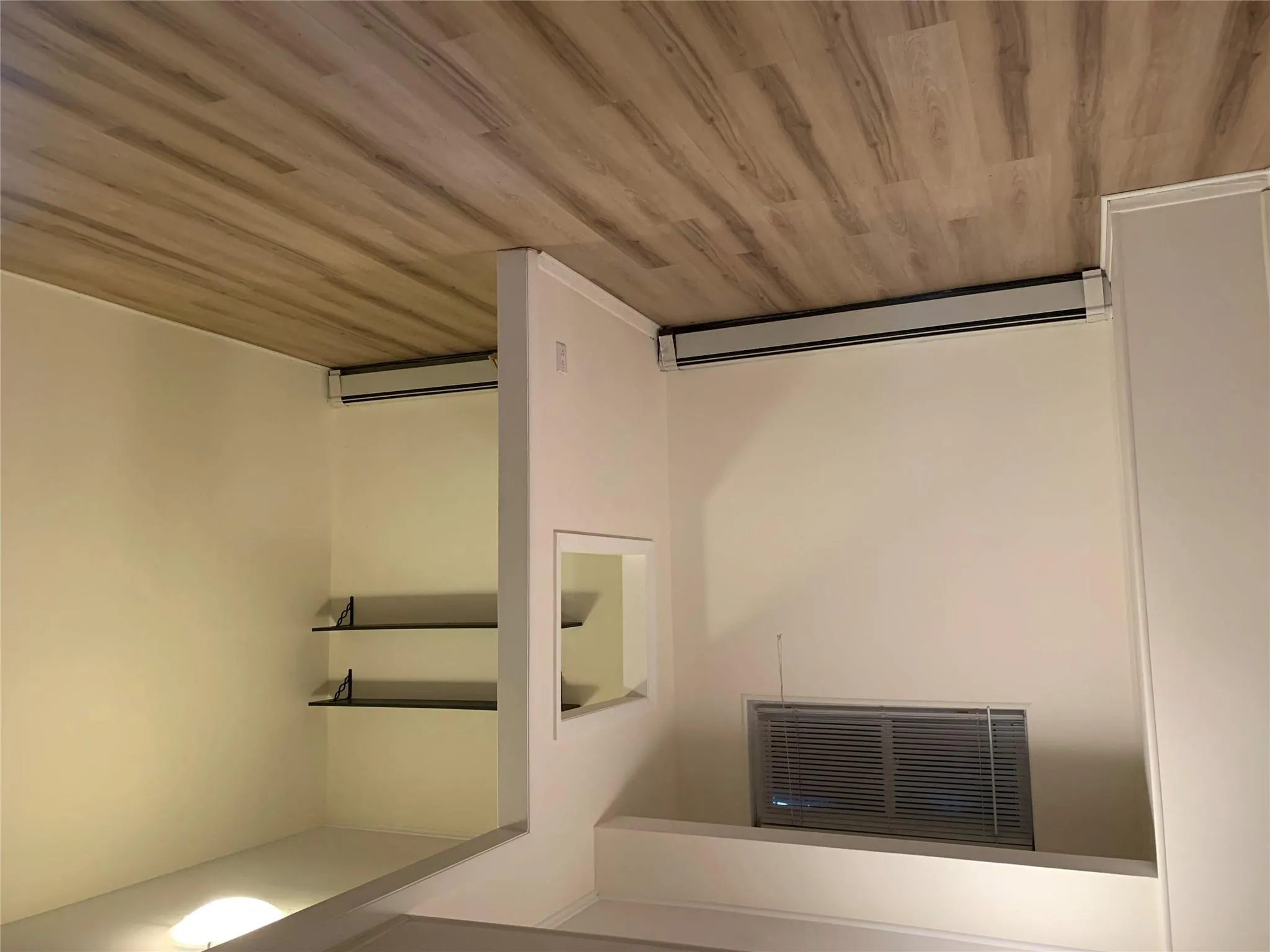 Finished basement with a baseboard radiator and light wood-style flooring Finished basement with a baseboard radiator and light wood-style flooring