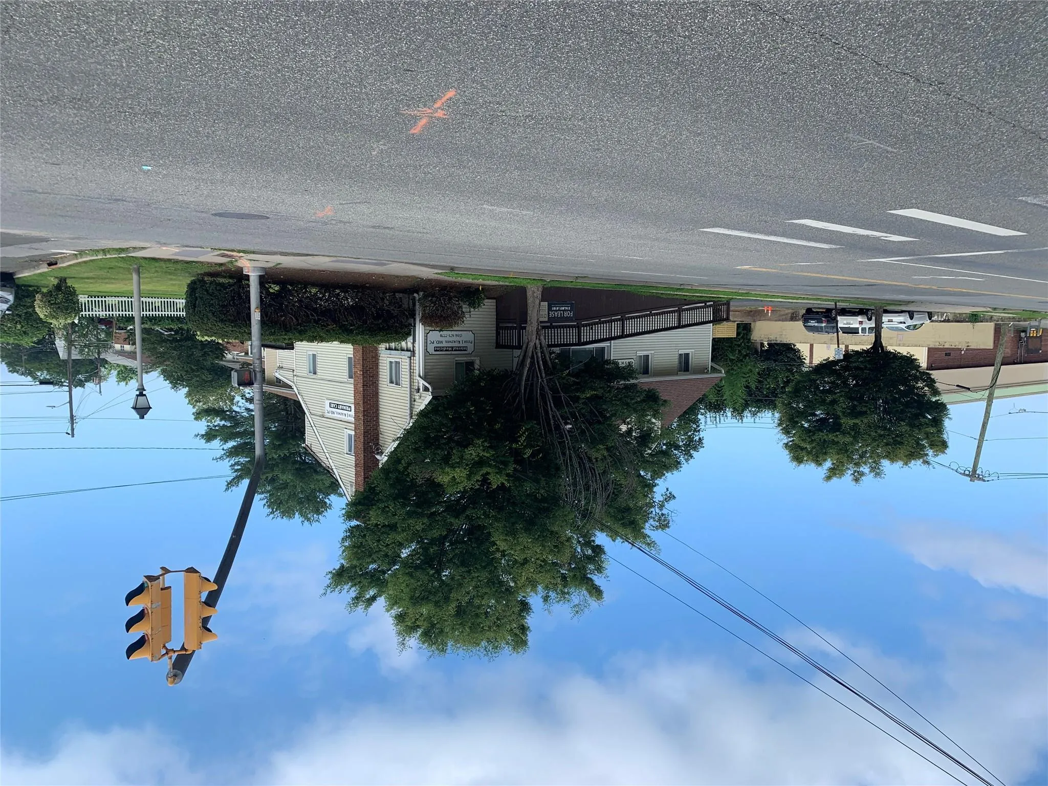 View of asphalt road featuring curbs, sidewalks, and street lighting View of asphalt road featuring curbs, sidewalks, and street lighting