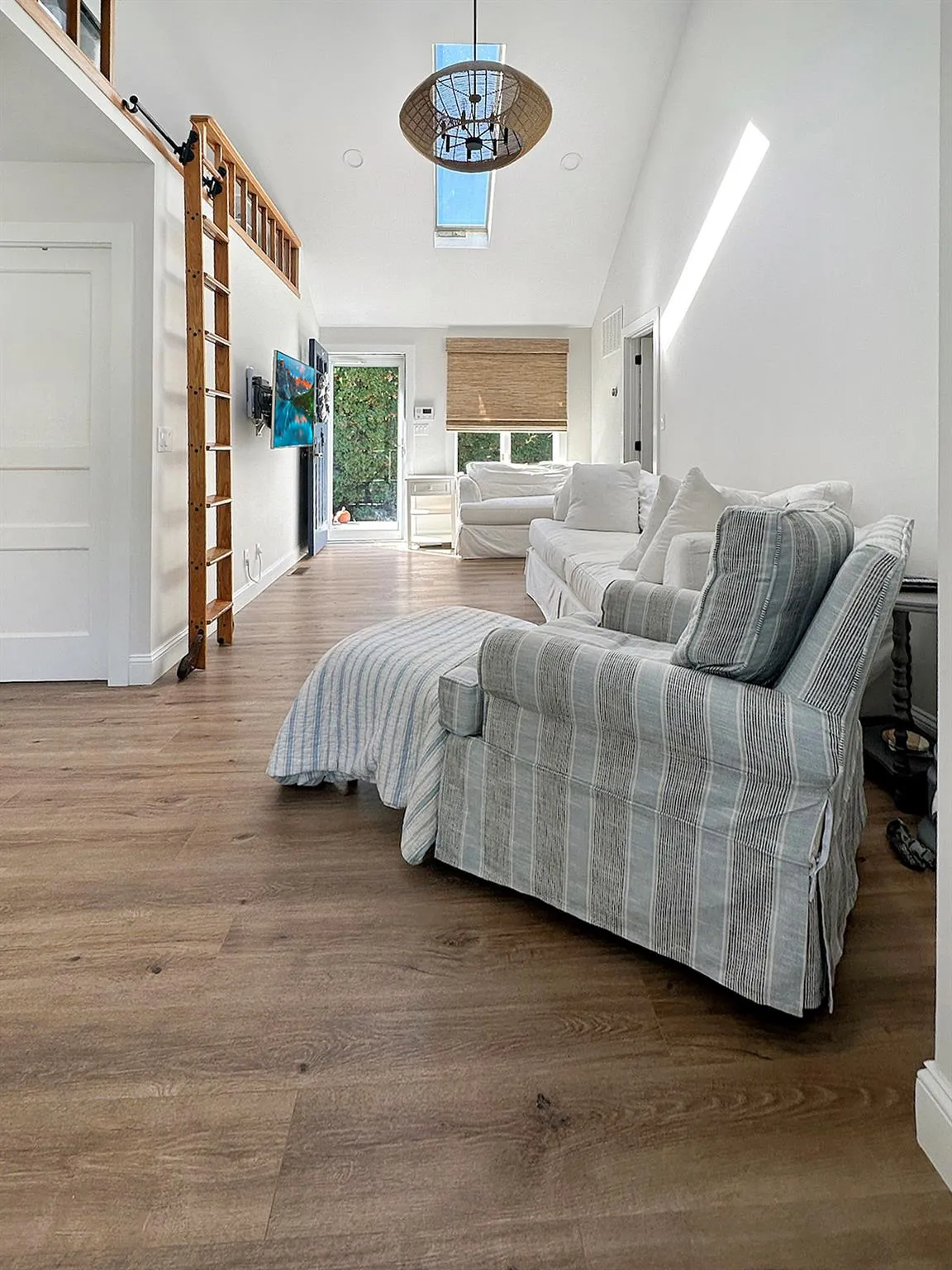 Bedroom featuring baseboards, visible vents, wood finished floors, high vaulted ceiling, and a notable chandelier Bedroom featuring baseboards, visible vents, wood finished floors, high vaulted ceiling, and a notable chandelier